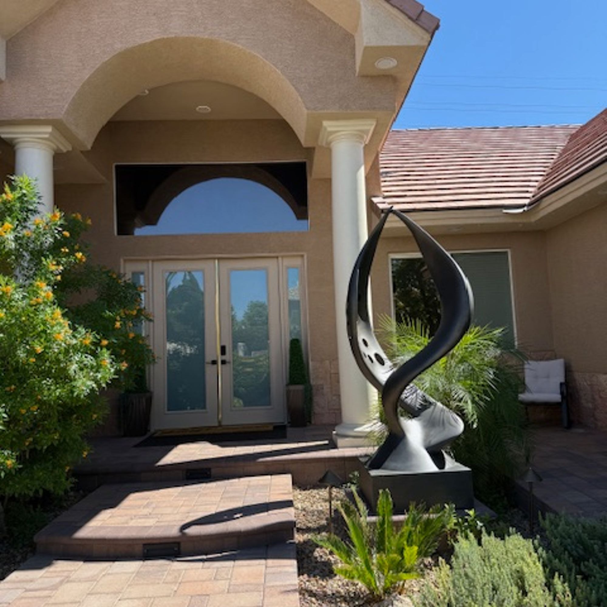 modern abstract outdoor metal sculpture installed at residential entrance in Boulder City Nevada