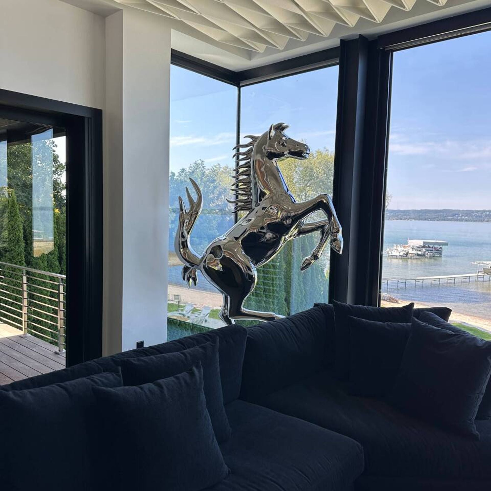 modern stainless steel rearing horse sculpture in luxury living room interior decor