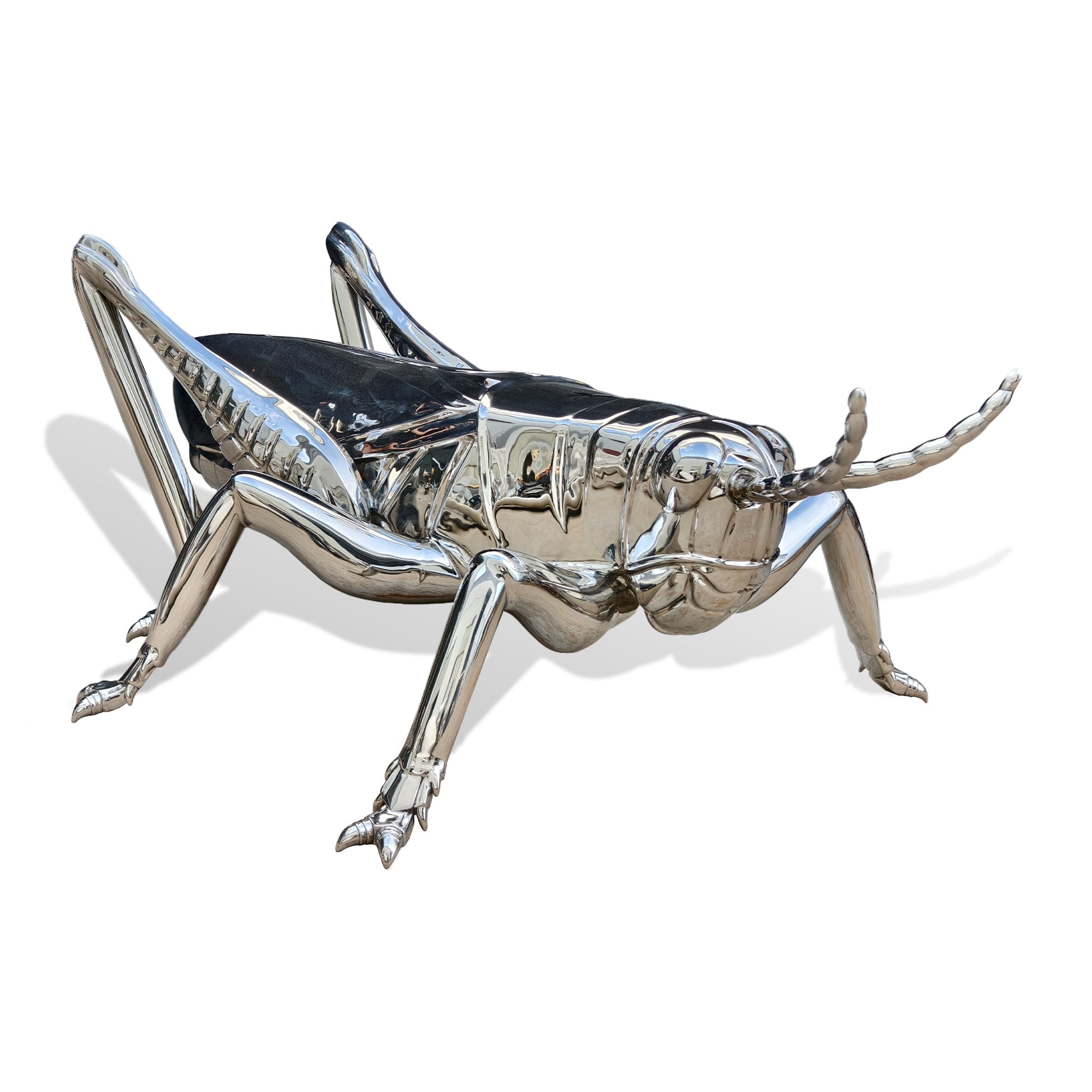 Metallic grasshopper sculpture on a white background