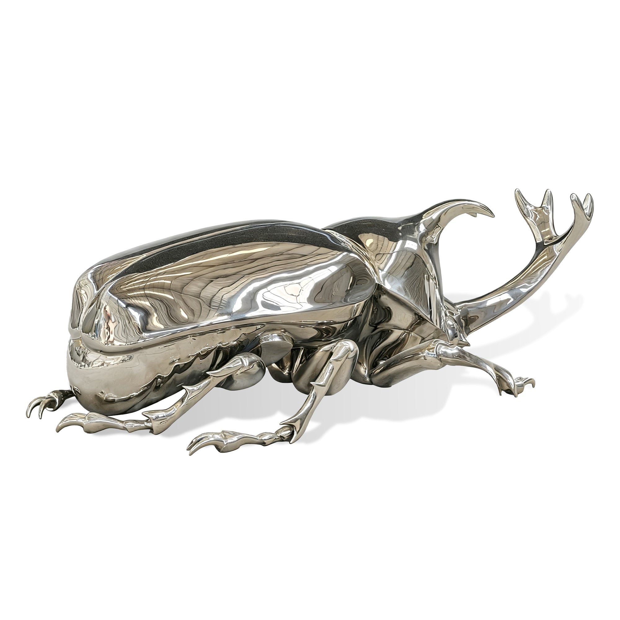 Silver beetle sculpture on a white background