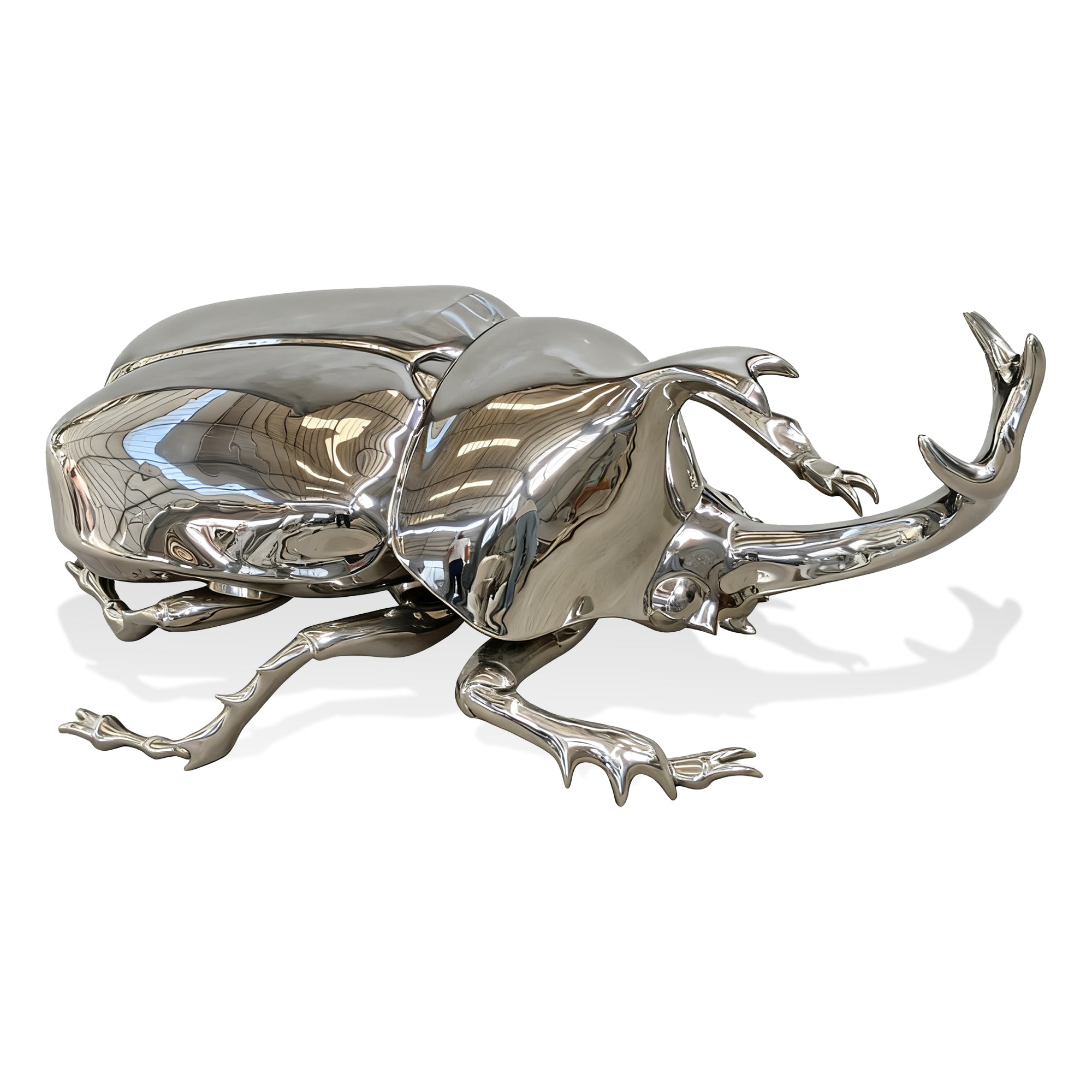 Metallic beetle sculpture on a white background