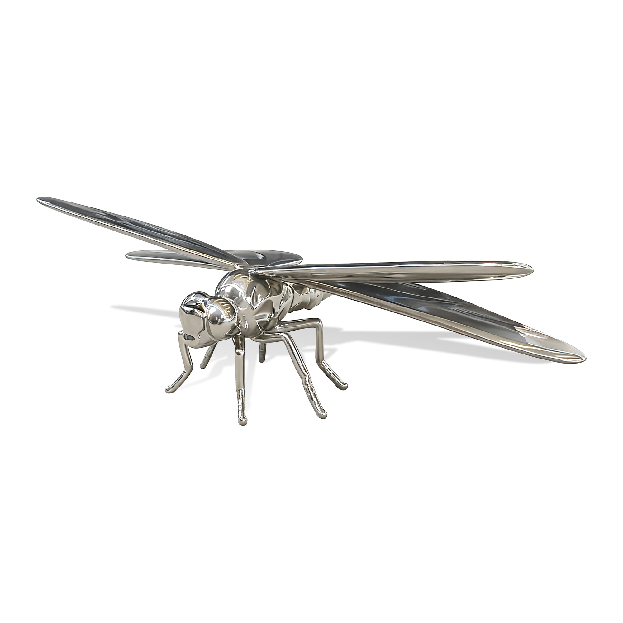 Silver dragonfly sculpture on a white background