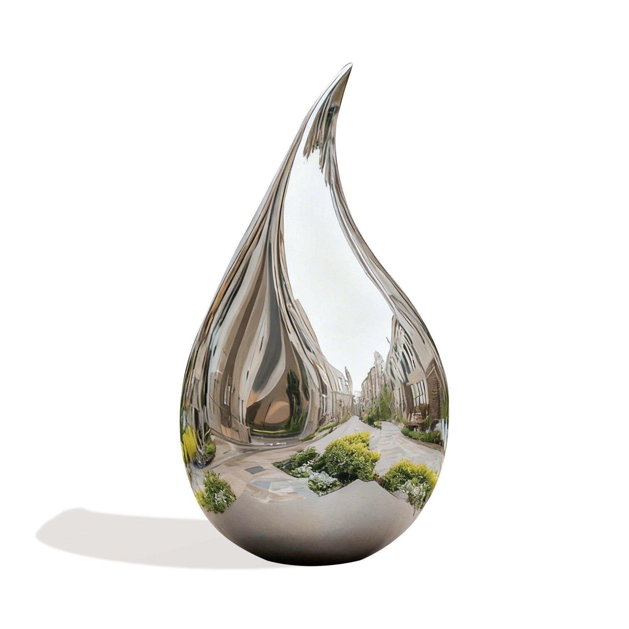 A polished stainless steel drop sculpture reflecting the surrounding garden and architecture, adding a touch of sophistication to the outdoor landscape.