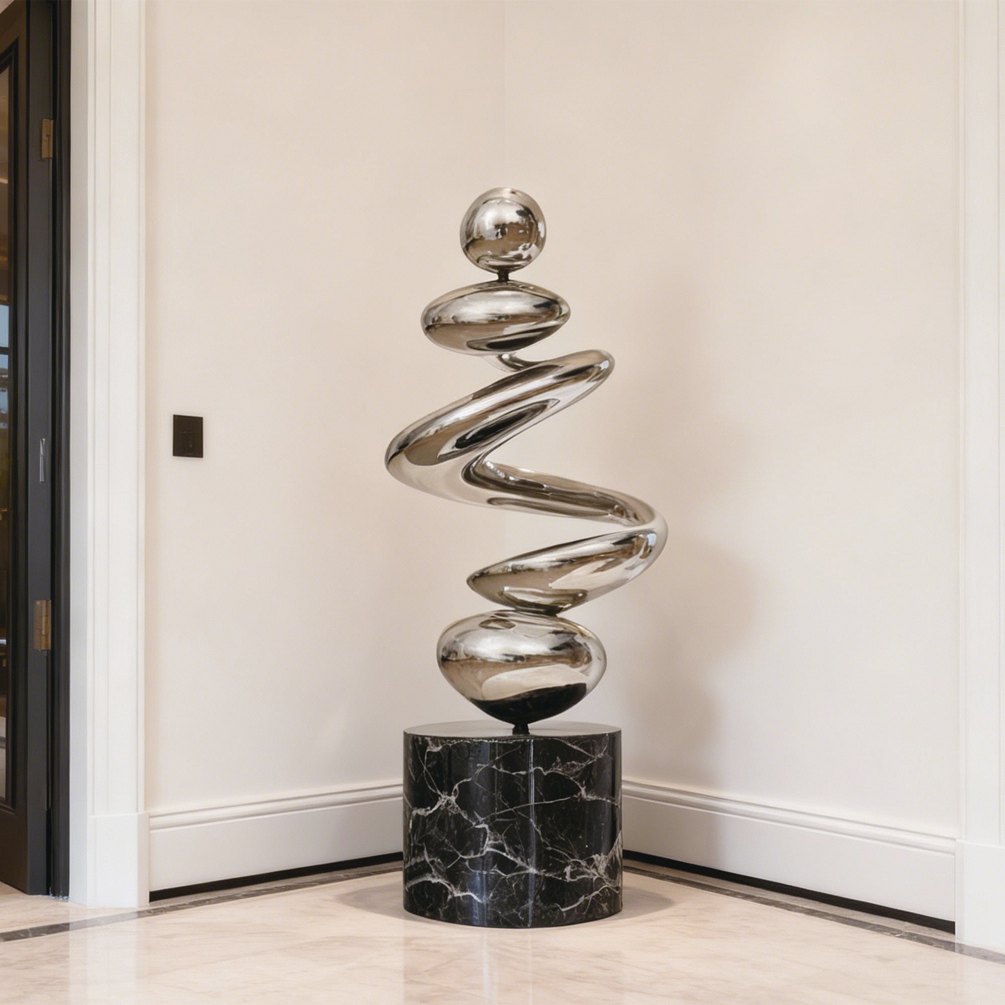 Modern sculpture with spiral design on a marble base in a room corner.