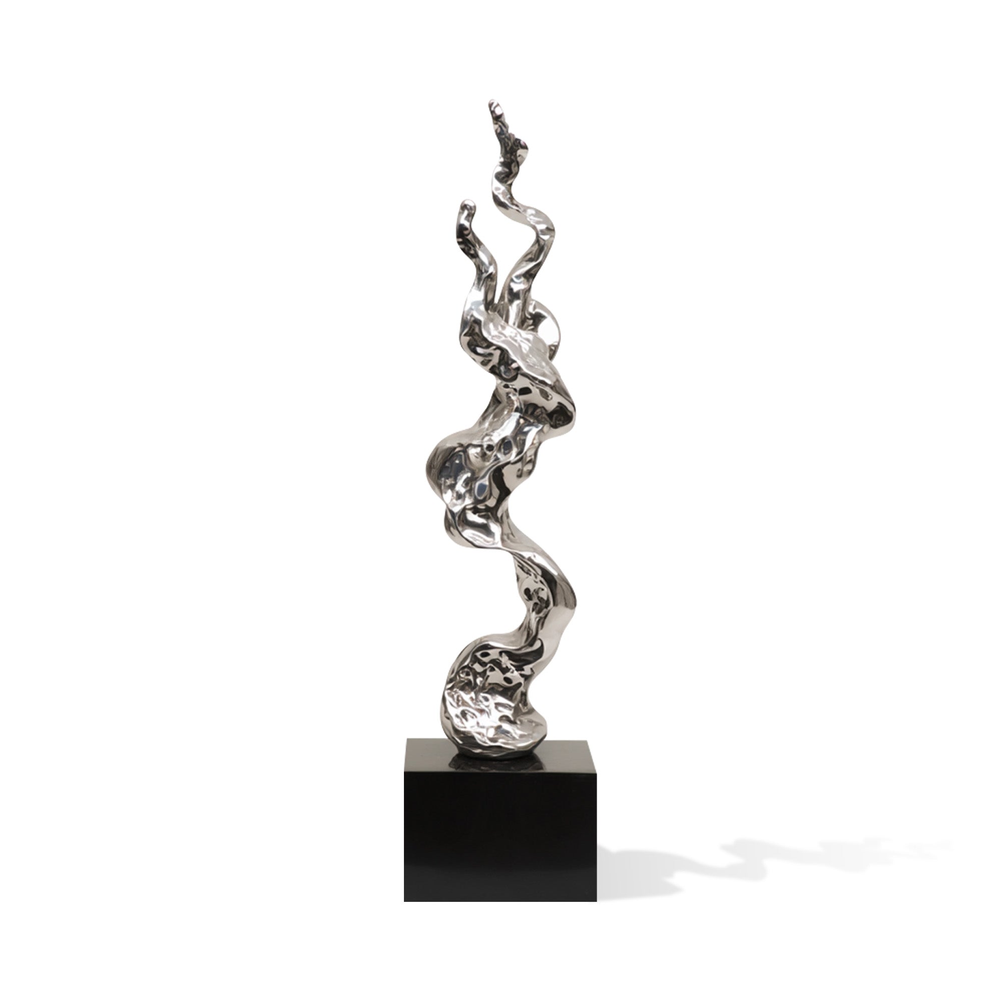 Silver abstract sculpture on a black base against a white background