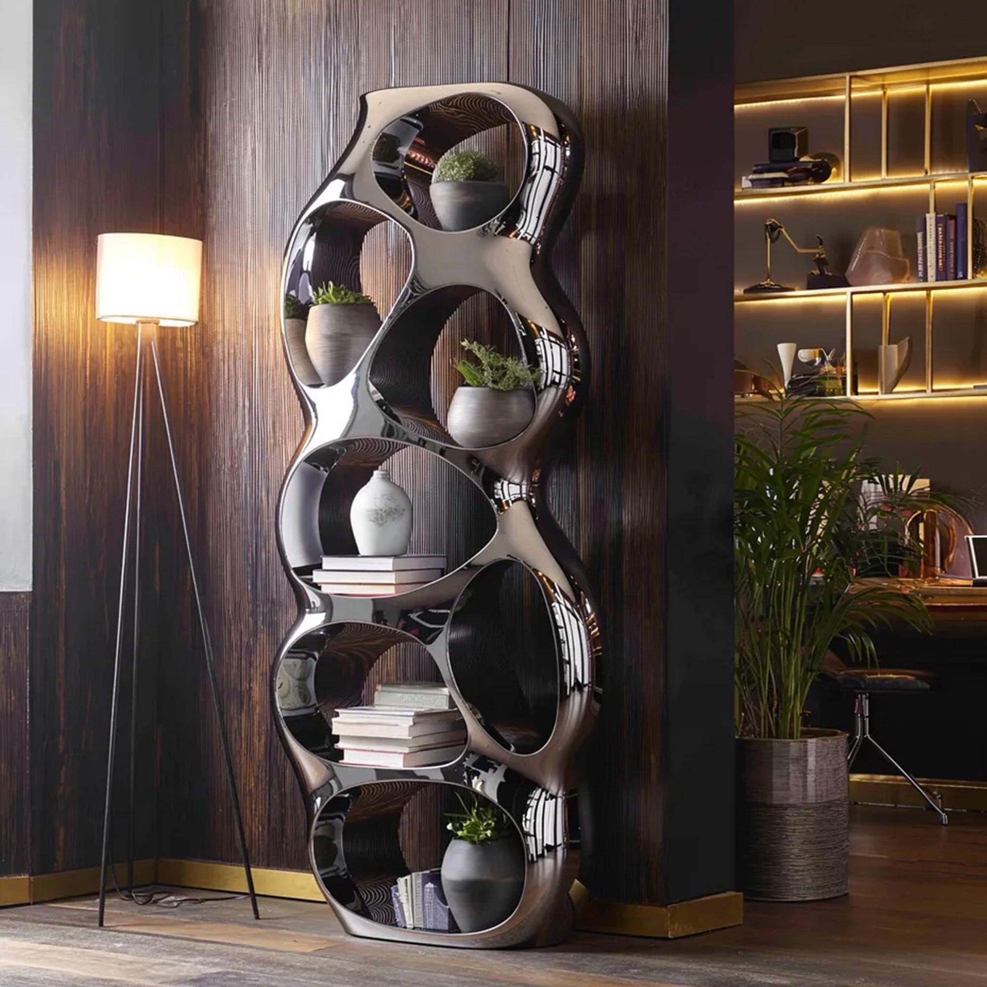 Mirror polished stainless steel bubble display shelf placed in a modern interior with reflective organic openings, plants, books, and decorative decor items.