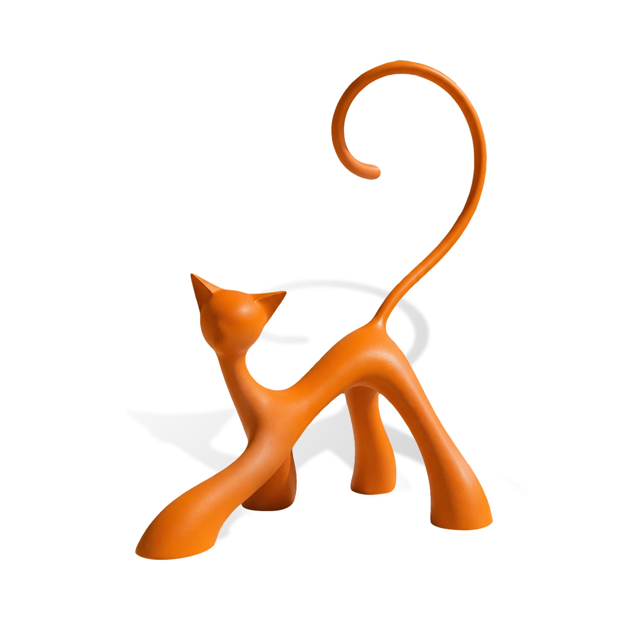 Orange abstract stainless steel cat sculpture with long curled tail, arched body, pointed ears, smooth painted finish, four stylized legs, and white background