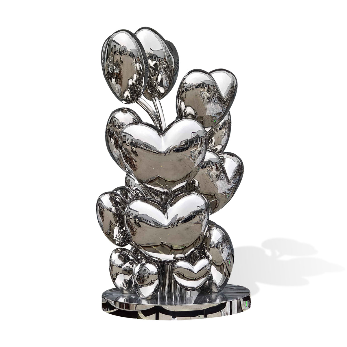 Custom mirror polished stainless steel heart sculpture with clustered heart forms shown from a side angle