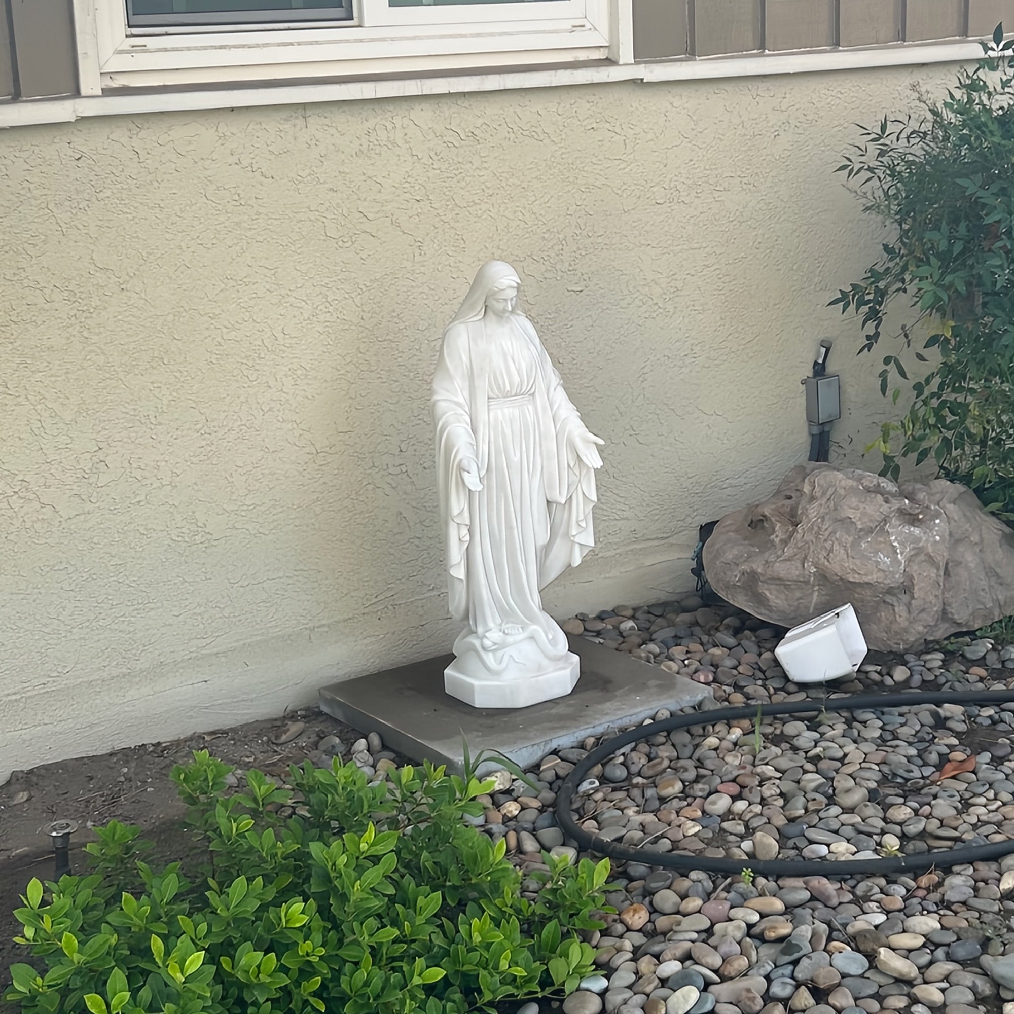 real installation of white marble virgin Mary in private estates