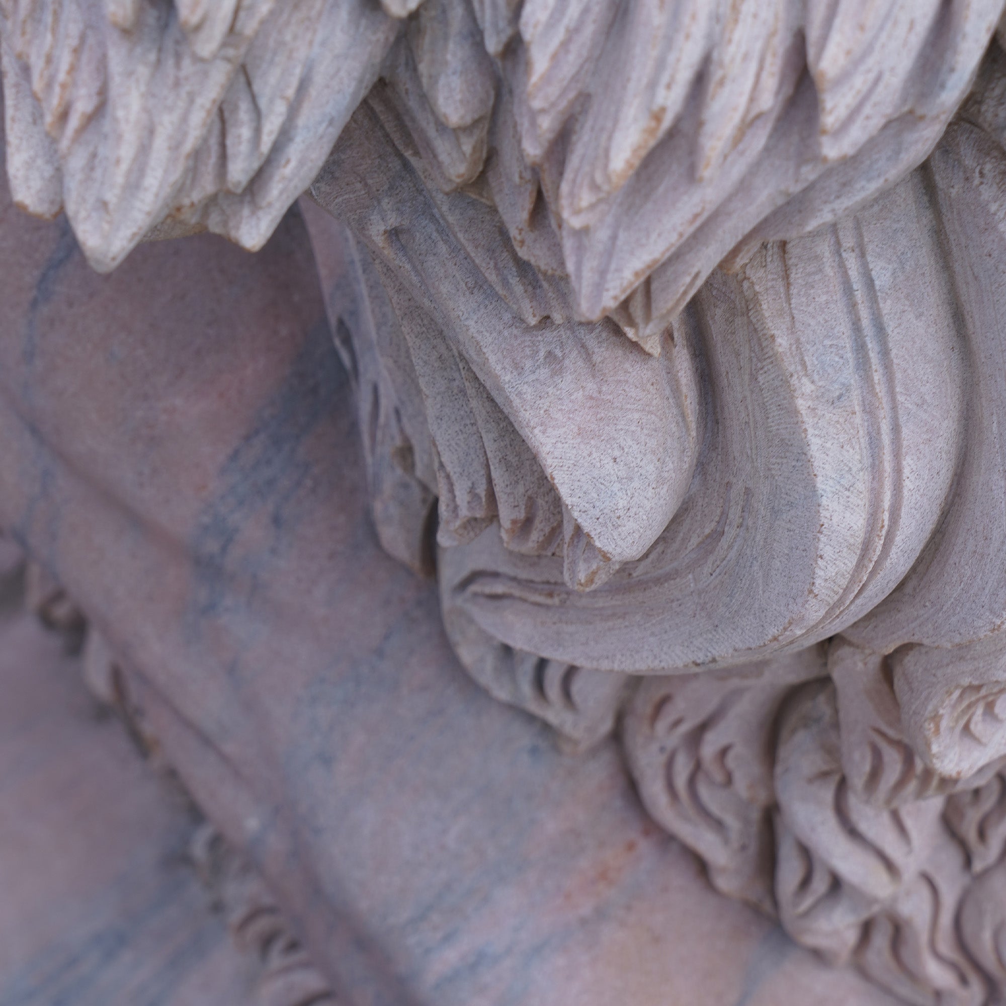 Close up of a marble lion sculpture, showcasing the intricate details of the mane and muscular structure, ideal for luxury gardens, private estates, and monumental entrances.