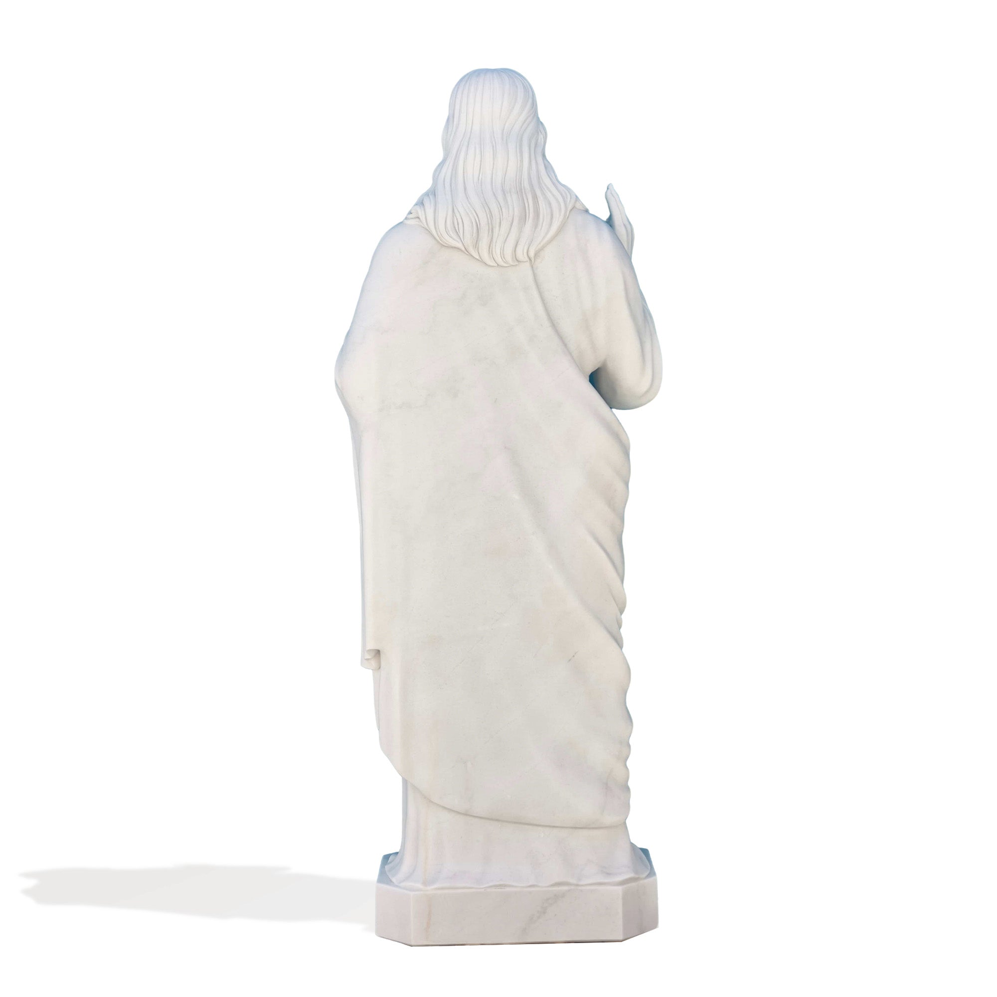 The Sacred Heart of Jesus marble statue placed in a serene garden setting, enhancing the spiritual ambiance of outdoor religious landscapes. Ideal for garden statues.