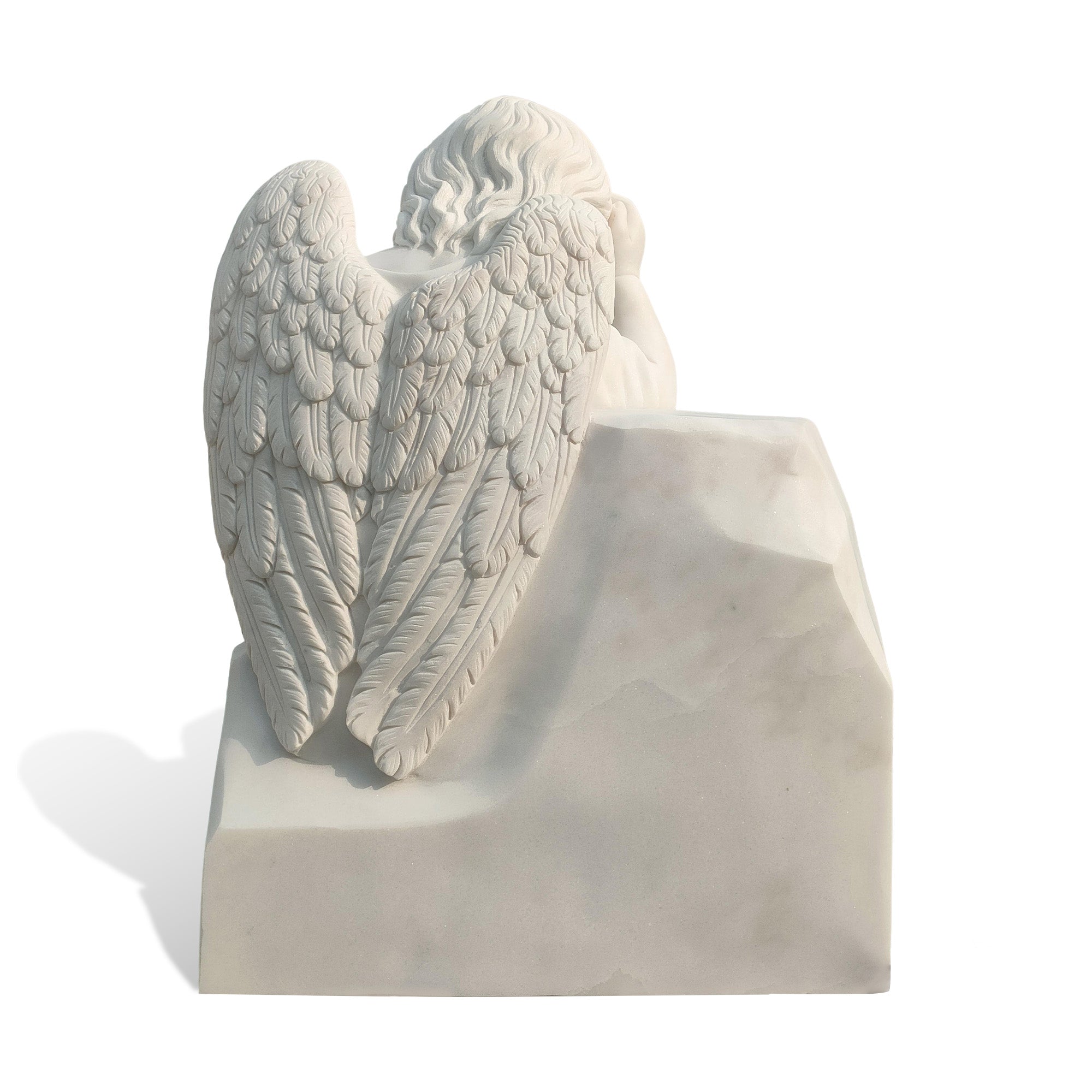 Detailed back view of angel wings carved in marble, showcasing feather texture and sculpture craftsmanship