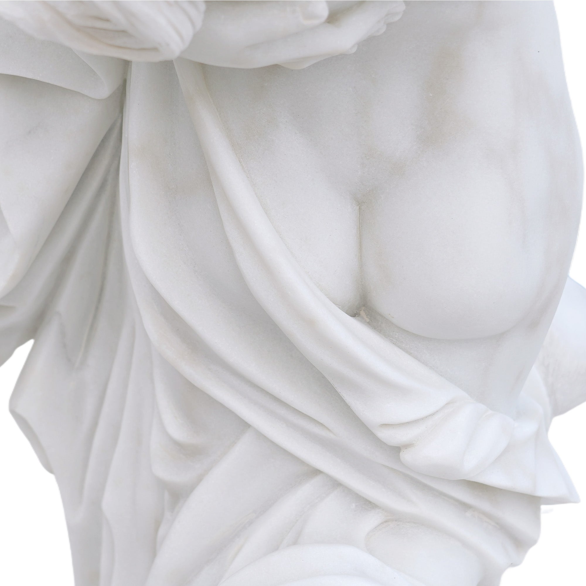 Close-up of the marble drapery folds, showing layered carving details and natural stone texture.