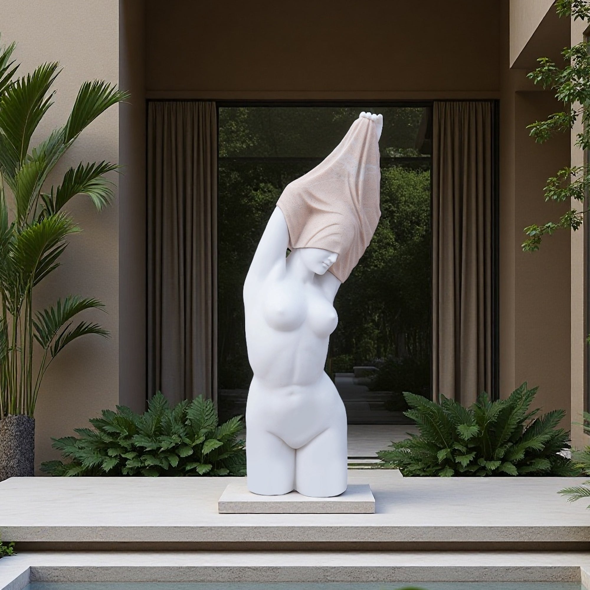 Outdoor placement of the “Naked Woman” replica, marble torso and granite veil creating a quiet focal point in a modern courtyard.