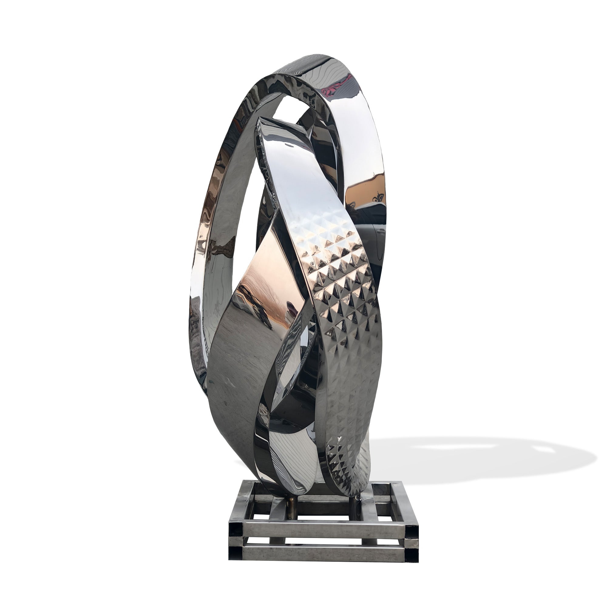 Side view of mirror finish cast stainless steel interlocking loop sculpture, contemporary metal art for luxury interiors or outdoor display, white background.