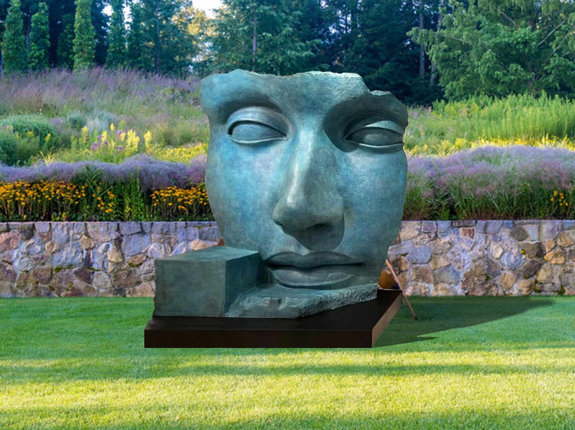 bronze green patina abstract face sculpture with a black base