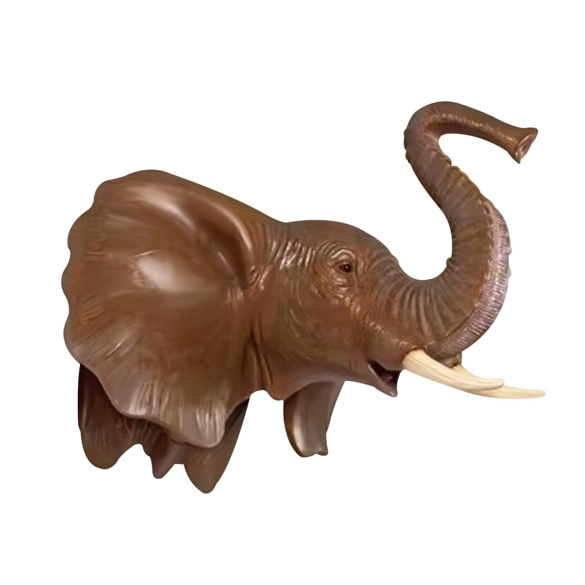 bronze elephant head wall sculpture with two white ivories