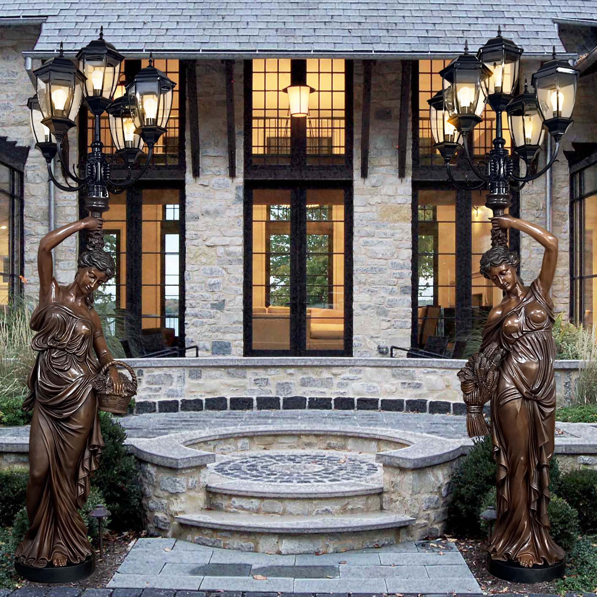 Pair of bronze lady sculptures with integrated LED lamp posts, elegantly positioned in front of a grand stone entrance.