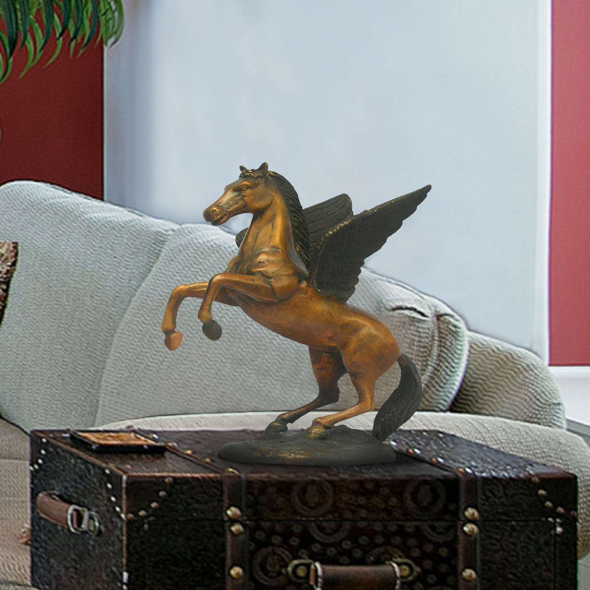 Bronze Pegasus statue in a rearing pose, displayed on a coffee table in a living room setting