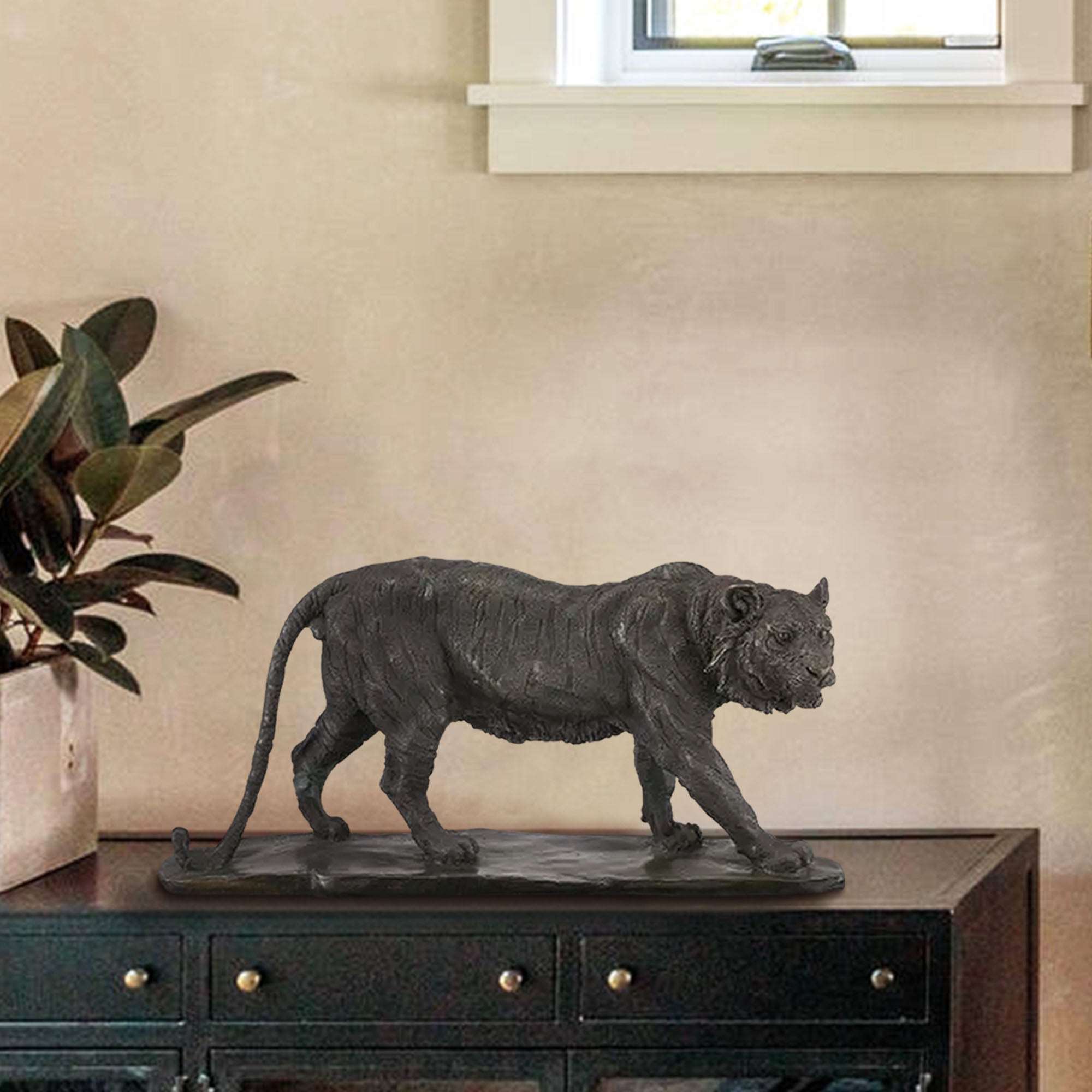 Bronze Saber Toothed Tiger Art Sculpture on a dark wooden console table in a modern living room