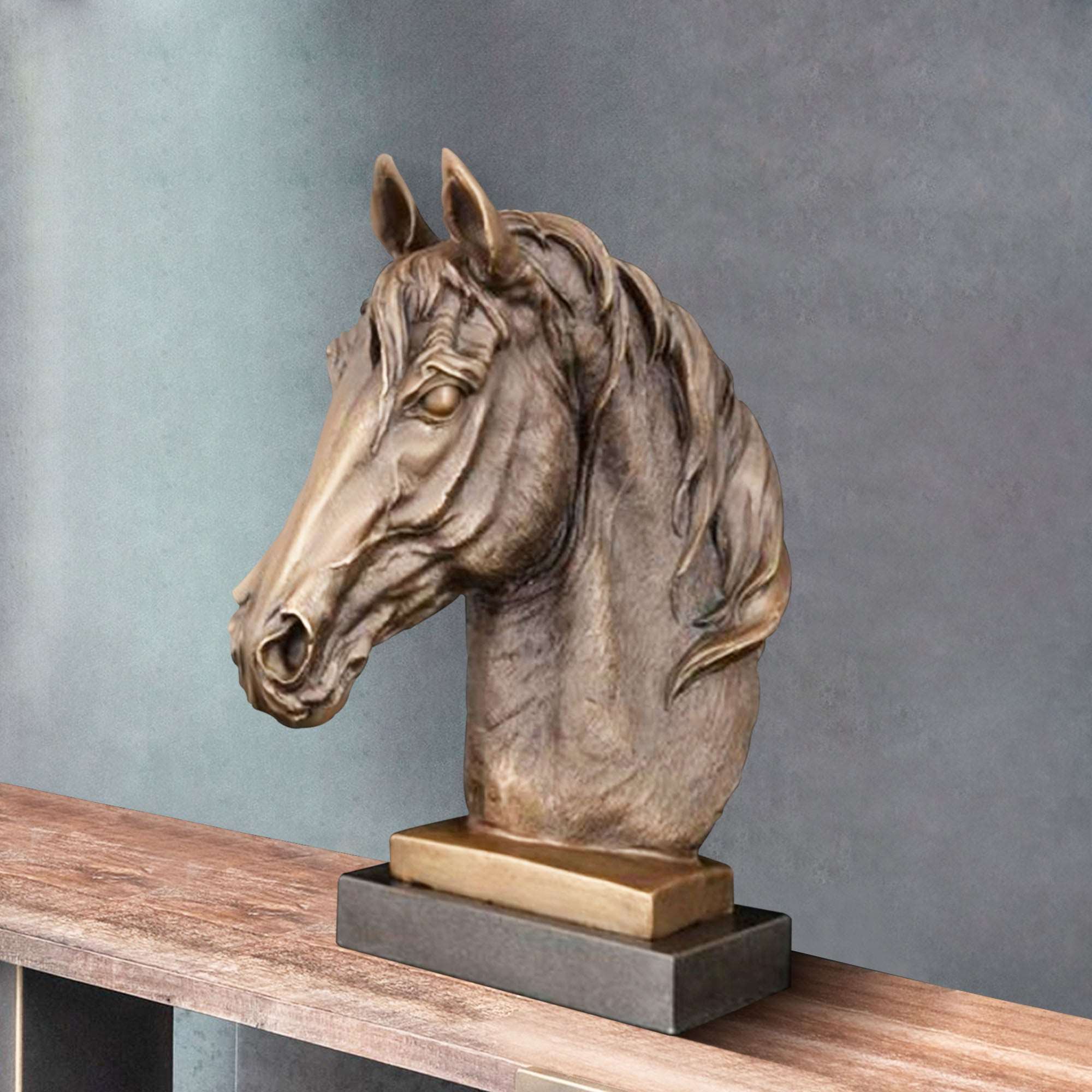 Indoor bronze art horse head sculpture with an antiqued finish, displayed on a wooden shelf in a modern interior