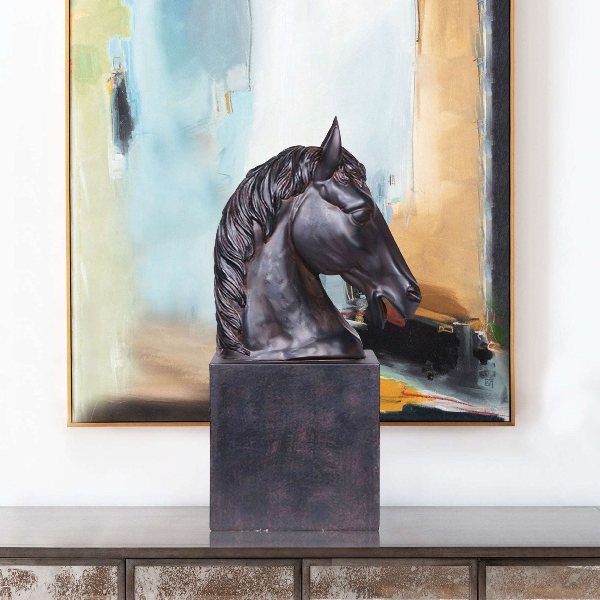 Cast bronze black horse head sculpture with a matte finish, displayed against a vibrant abstract background in a modern interior