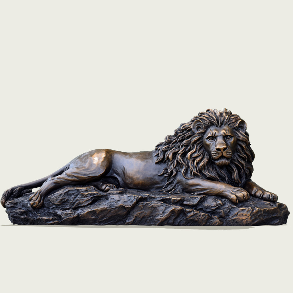 Majestic Reclining Bronze Lion Sculpture with a classic bronze finish, resting on a rocky base