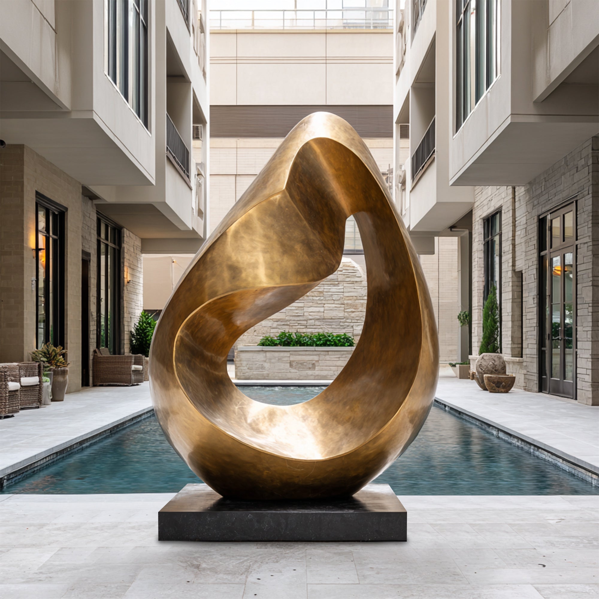 Bronze abstract sculpture in front of a modern building with a pool