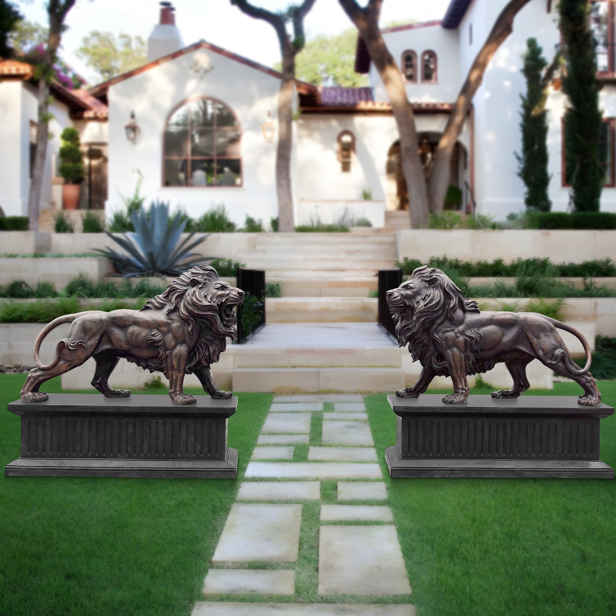 Bronze lion statues on a grassy lawn with a house in the background