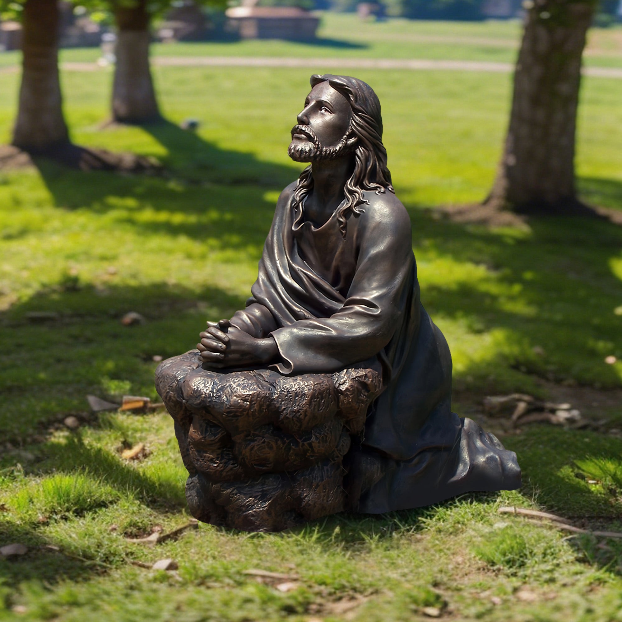 “The Prayer of Christ” Bronze statue of a seated figure on a rock in a park setting