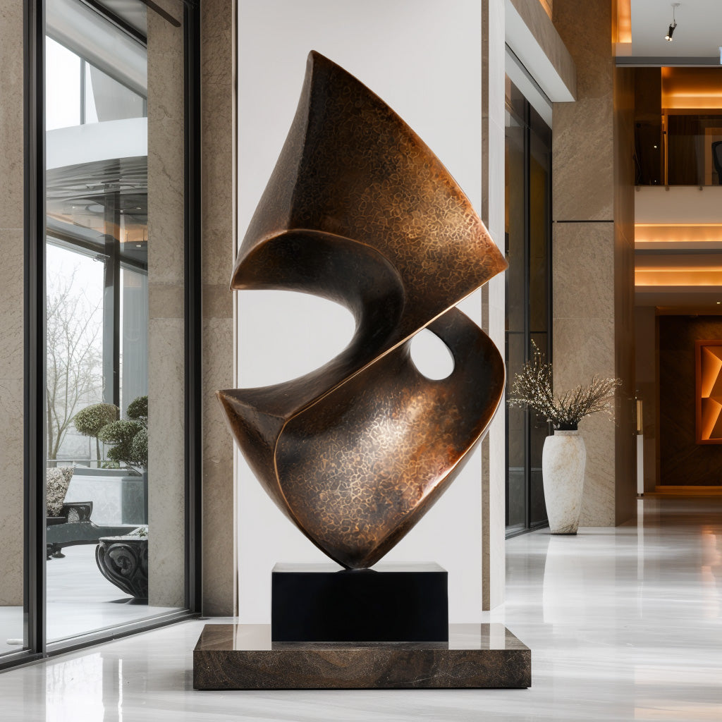 Abstract bronze sculpture in a modern indoor setting with large windows.