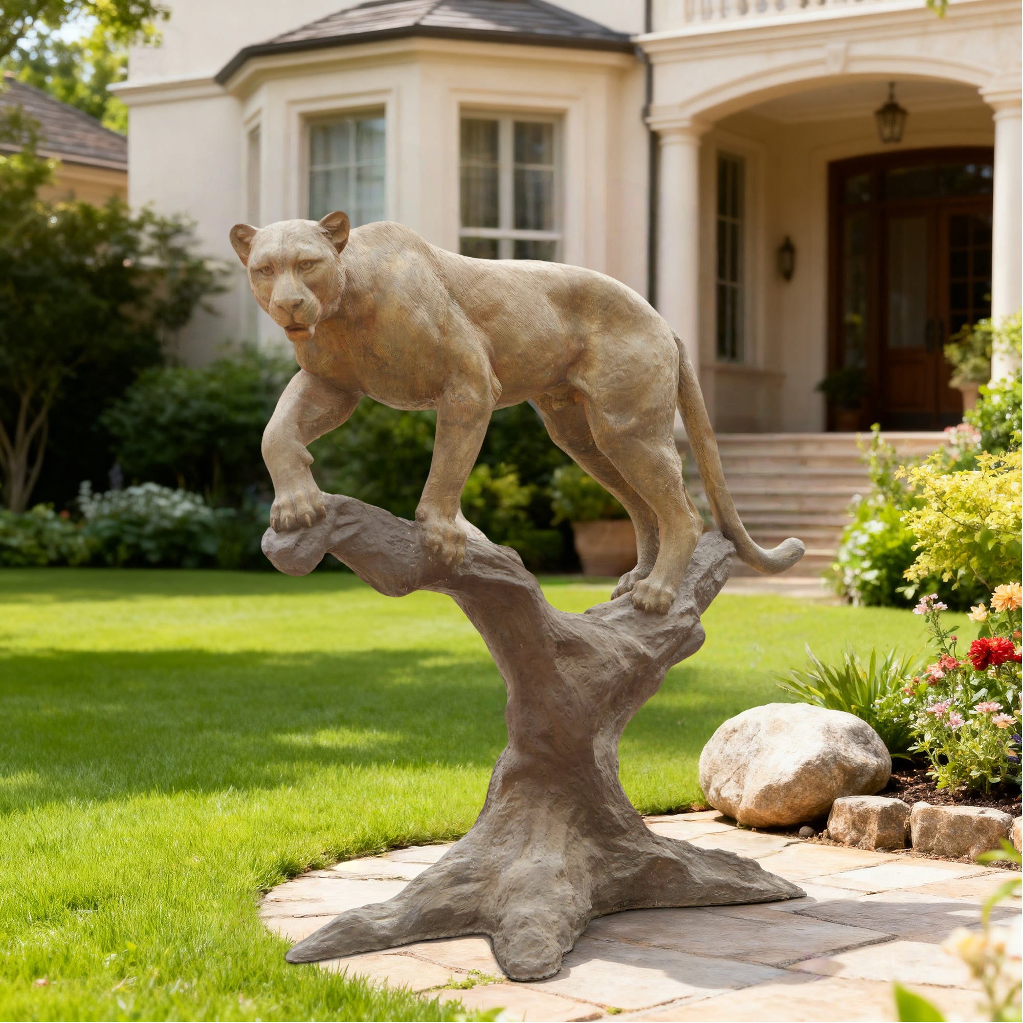 Statue of a Lioness on a branch in front of a house