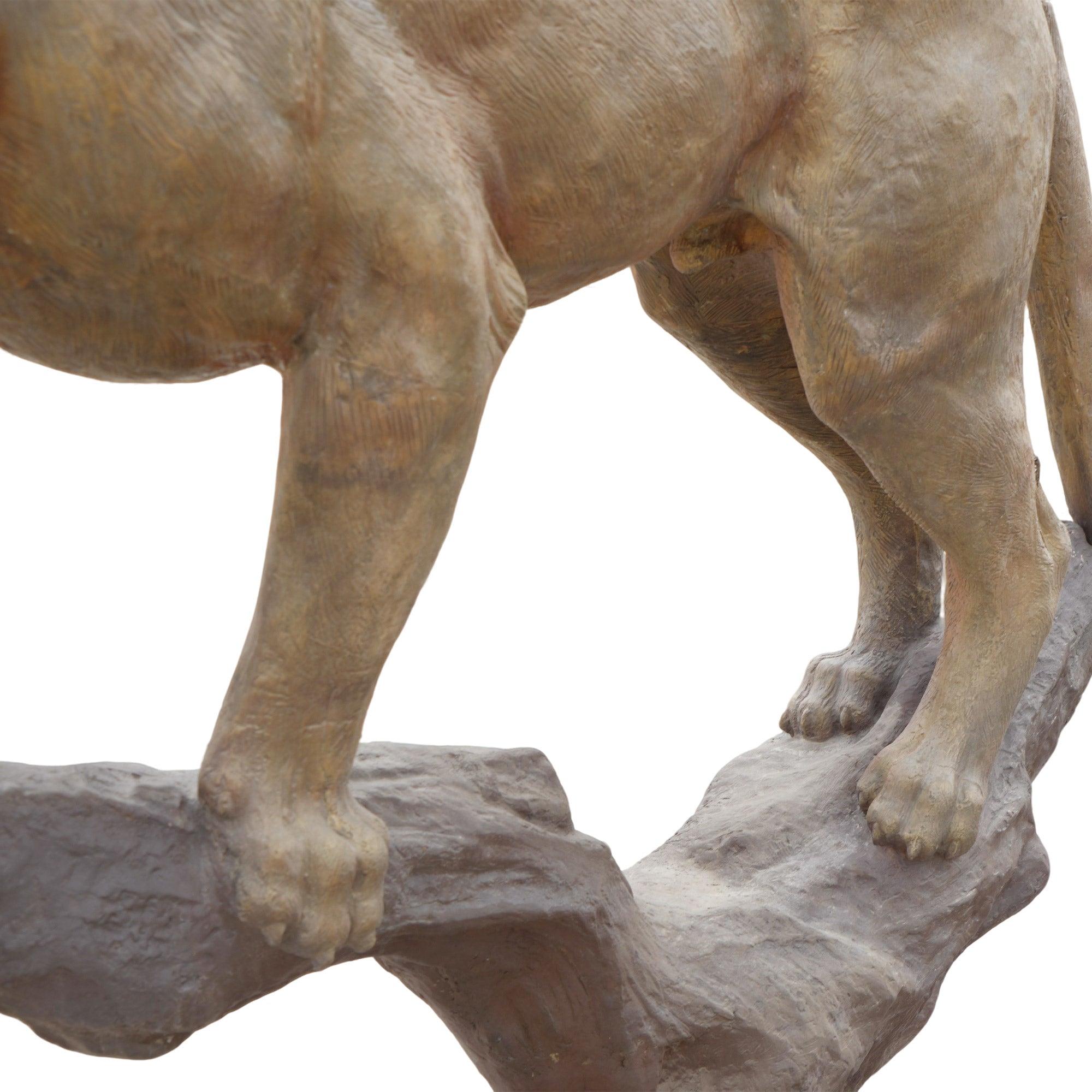 Statue of a lion standing on a rock with a plain background