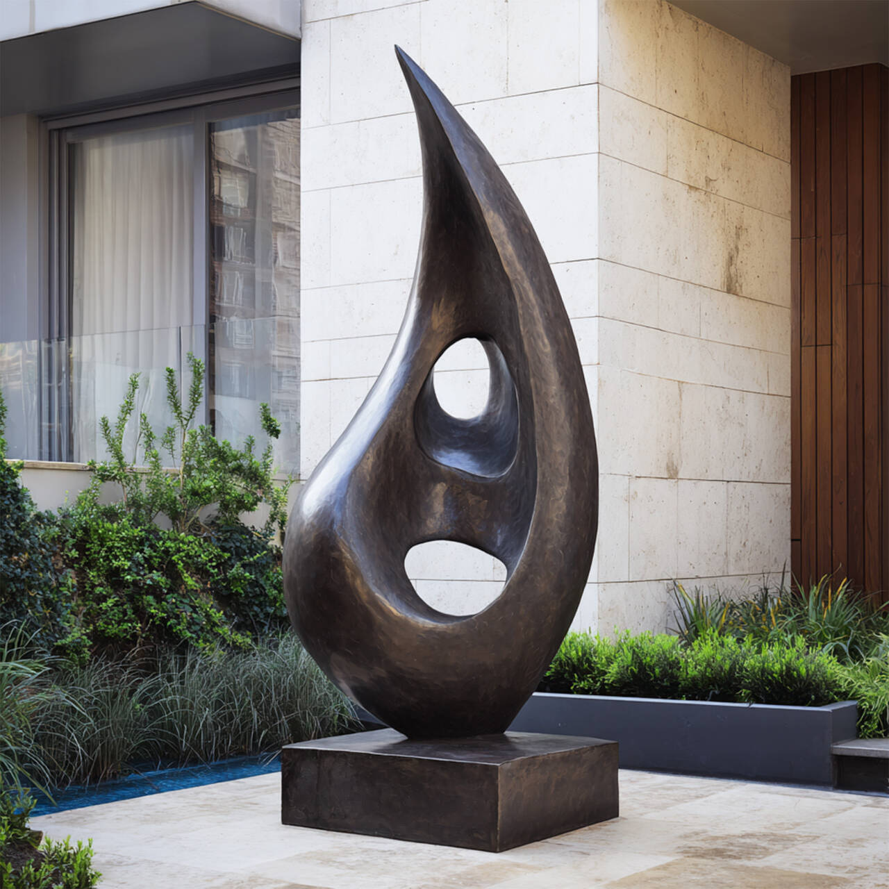 Large abstract bronze outdoor sculpture in dark patina with two openings, placed on a square base as a modern courtyard garden landscape focal point