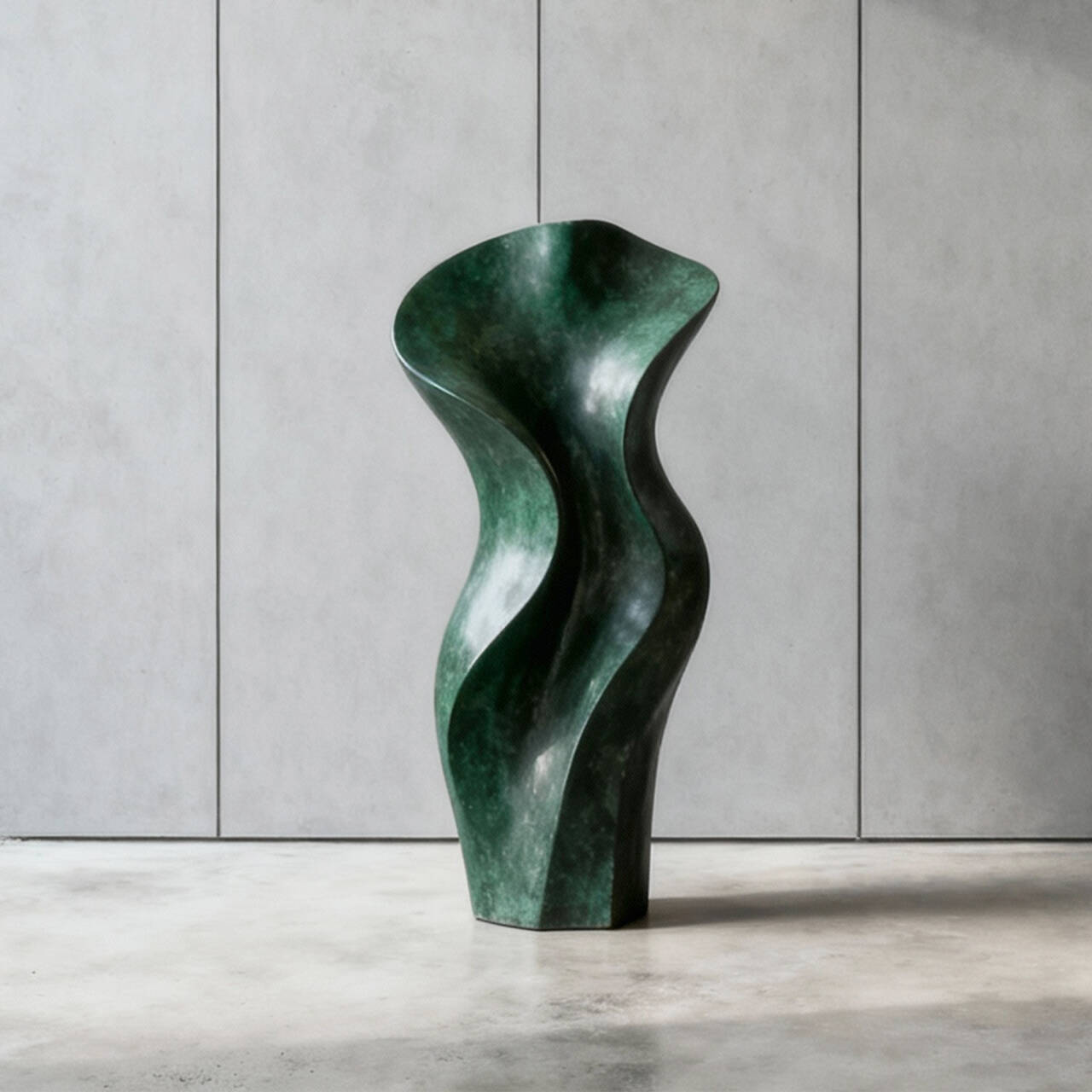 Abstract green bronze sculpture on a gray surface with a neutral background