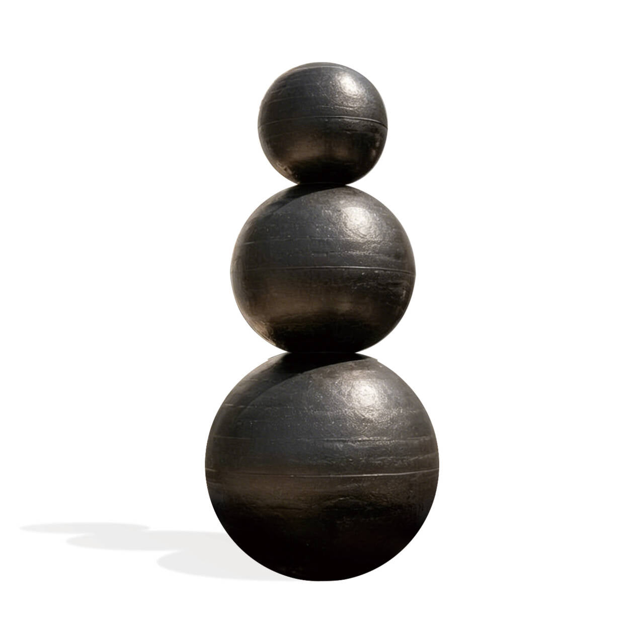 Stack of three dark wooden spheres on a white background