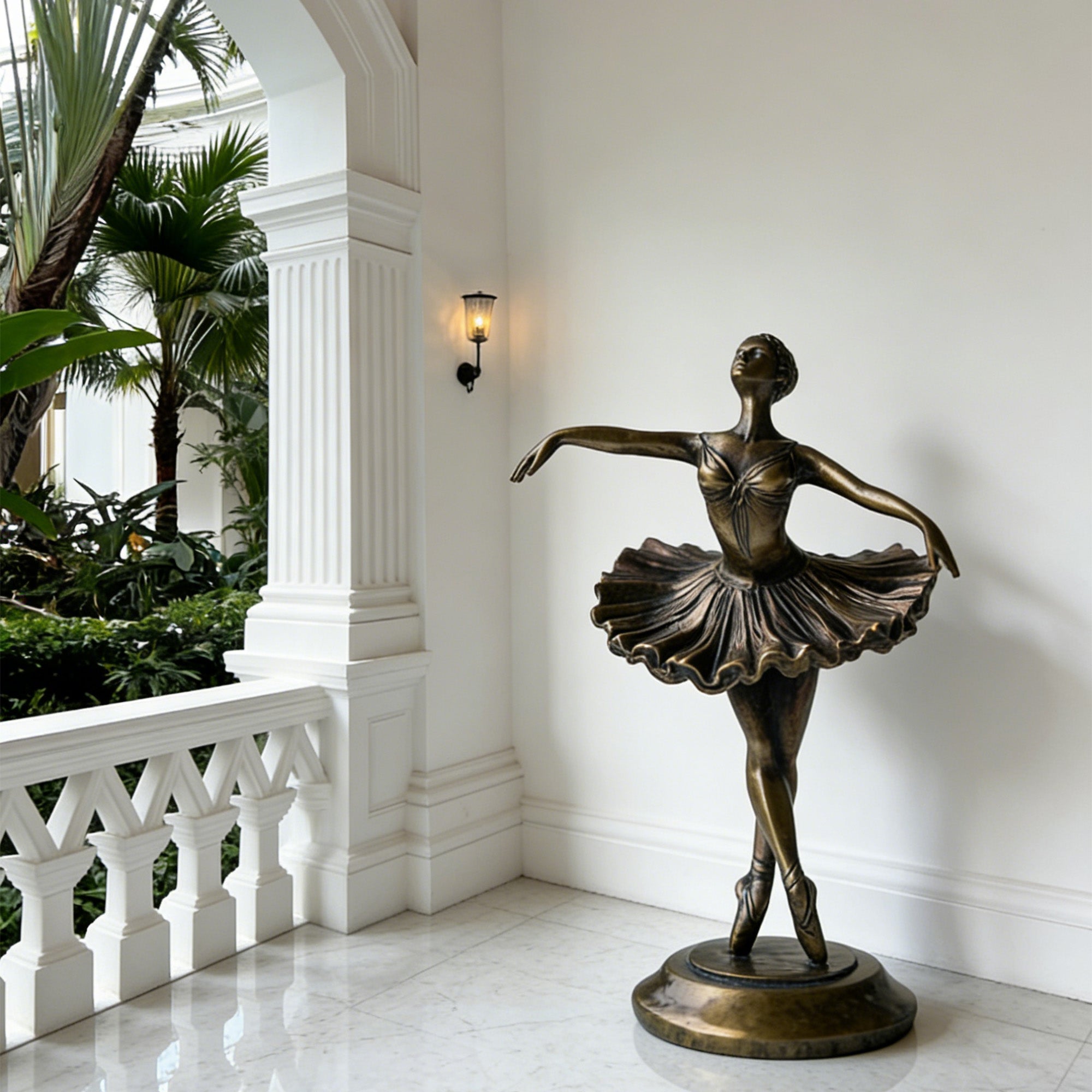 Bronze statue of a dancer in a elegant interior setting with white walls and a balcony.