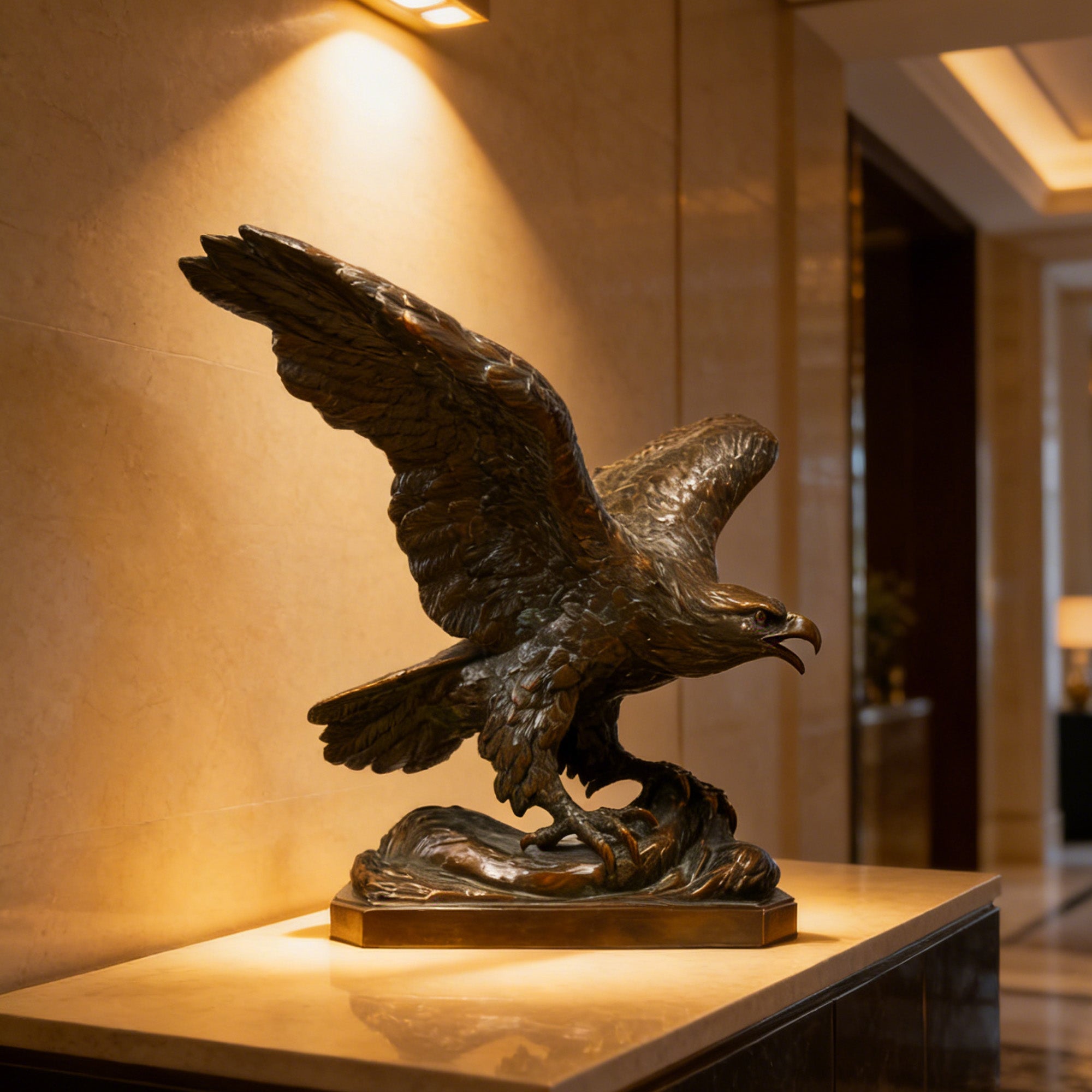 Bronze eagle sculpture on a pedestal in a warmly lit room.