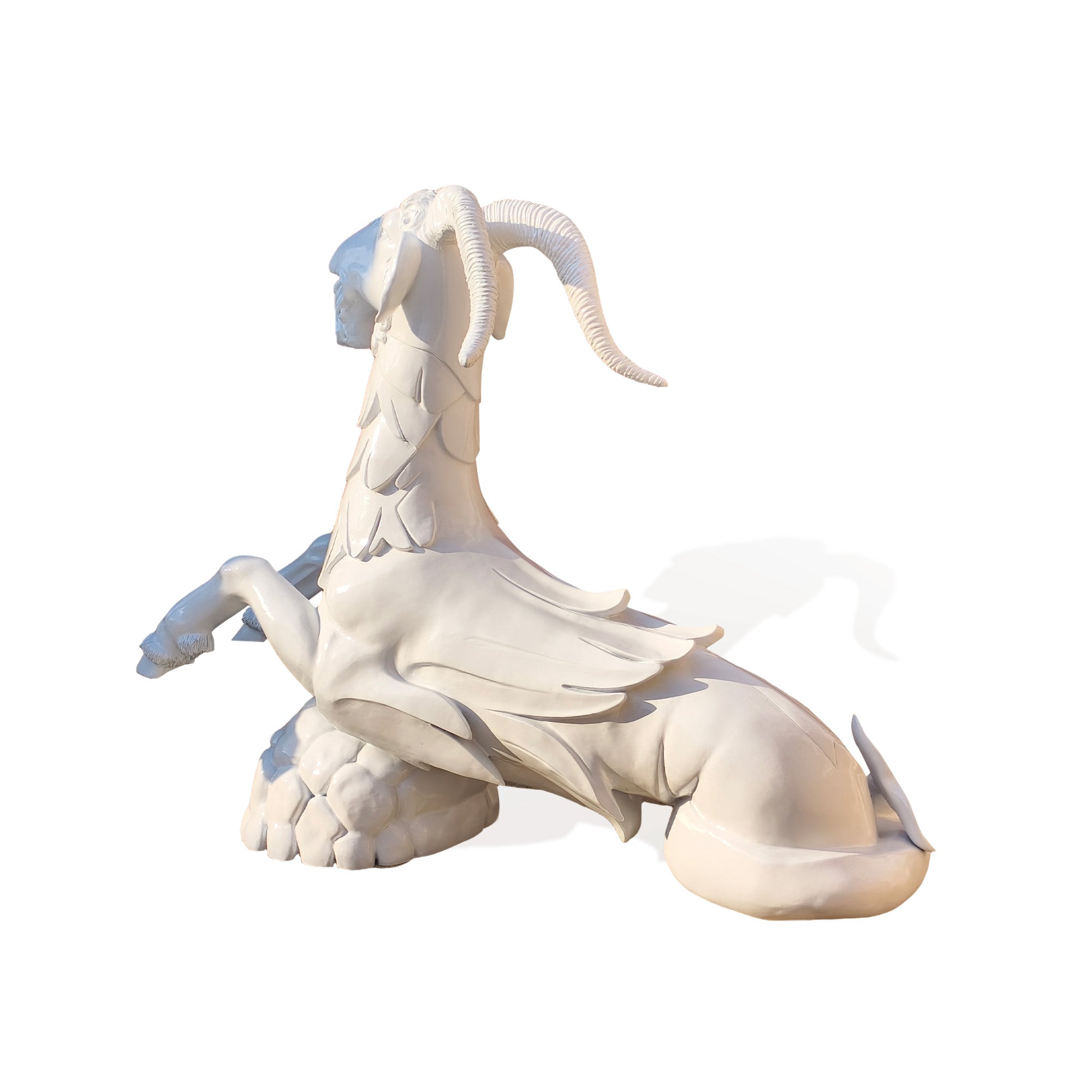 Side view of zodiac Capricorn fountain sculpture showing the mythical sea goat form with goat front body fish tail and rock base