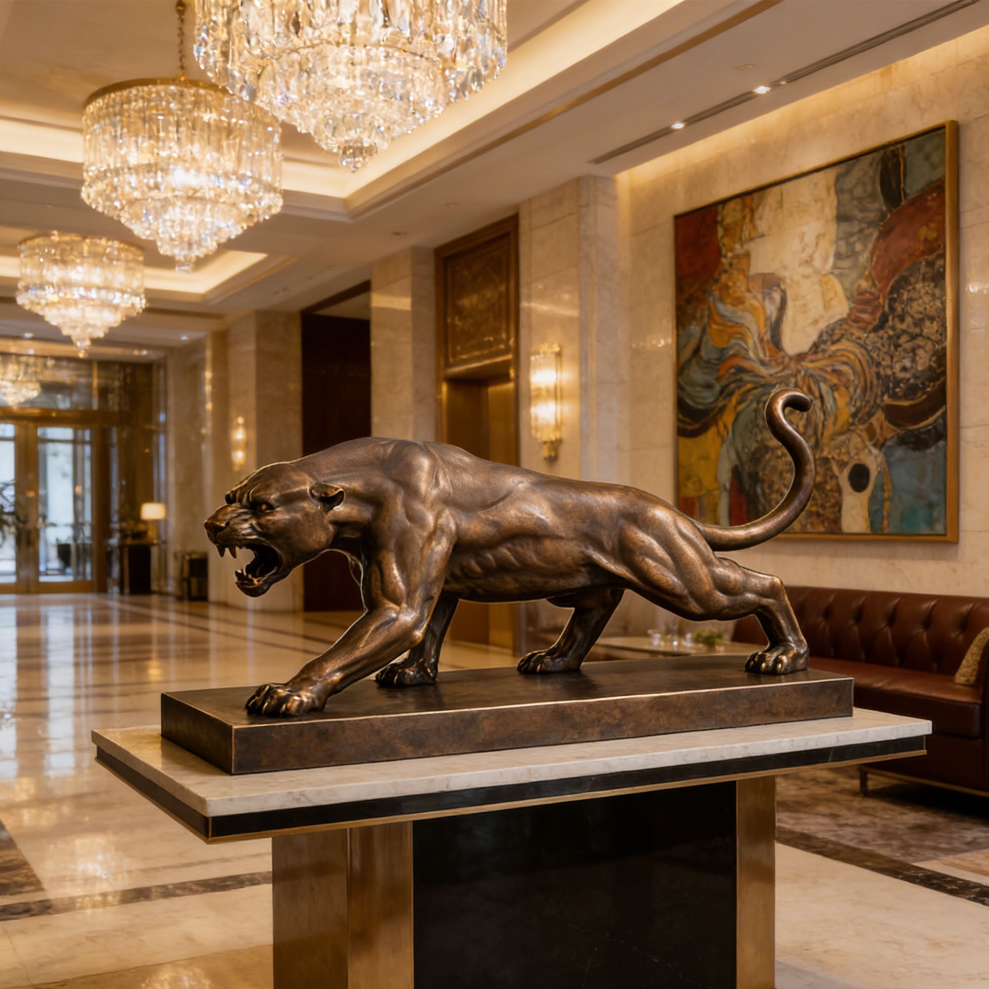 Bronze panther statue in a luxurious lobby with chandeliers and artwork.