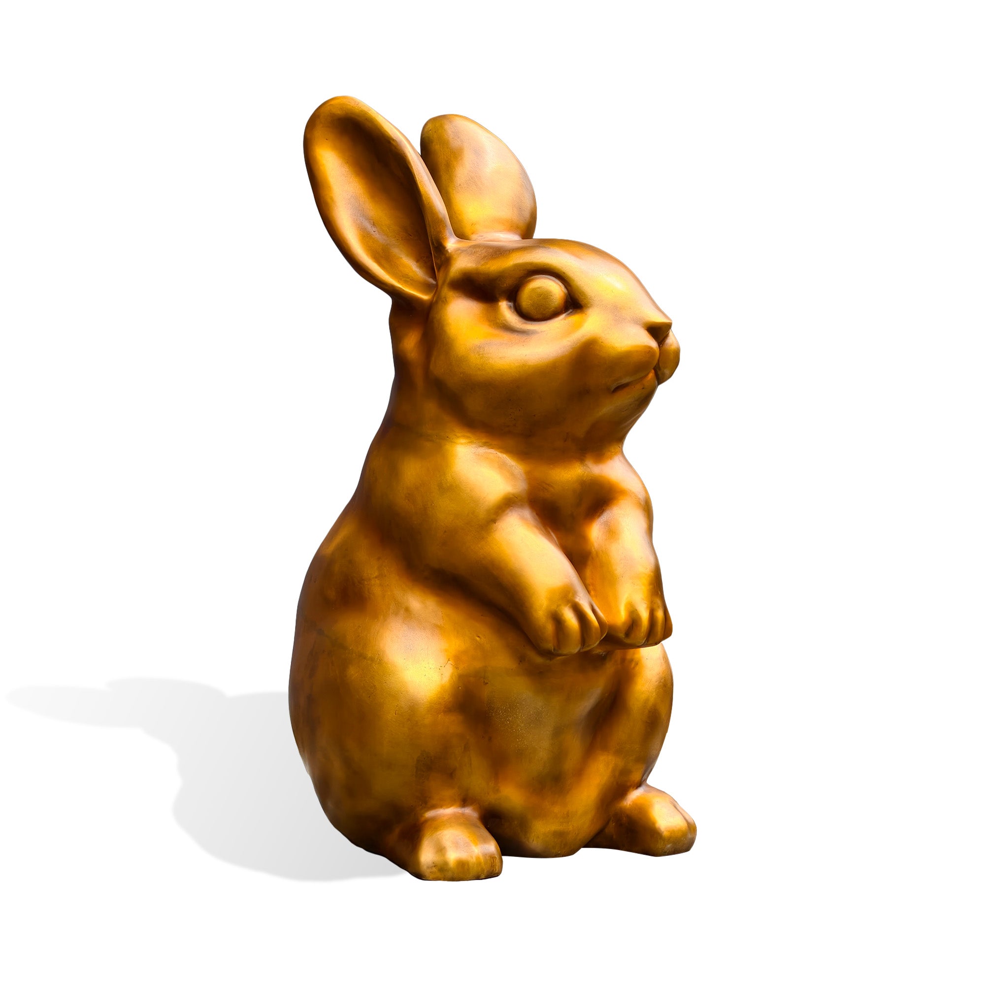 Front-right three-quarter view of a golden bronze rabbit sculpture with tall ears, expressive facial details, a rounded belly, and lifted front paws on a white background.