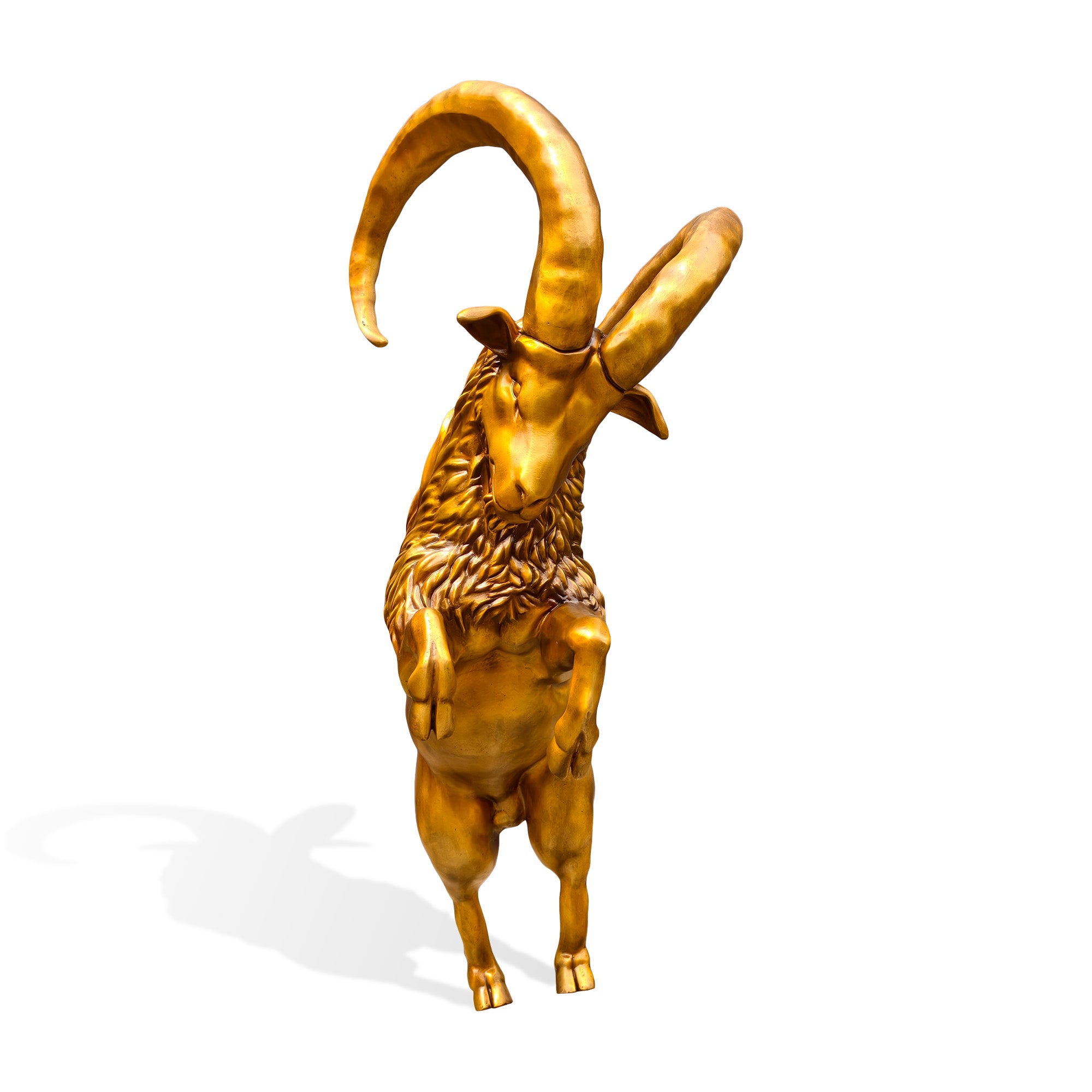 Front view of a golden bronze mountain goat sculpture standing on its hind legs with lifted front hooves, prominent curled horns, and finely sculpted neck hair.