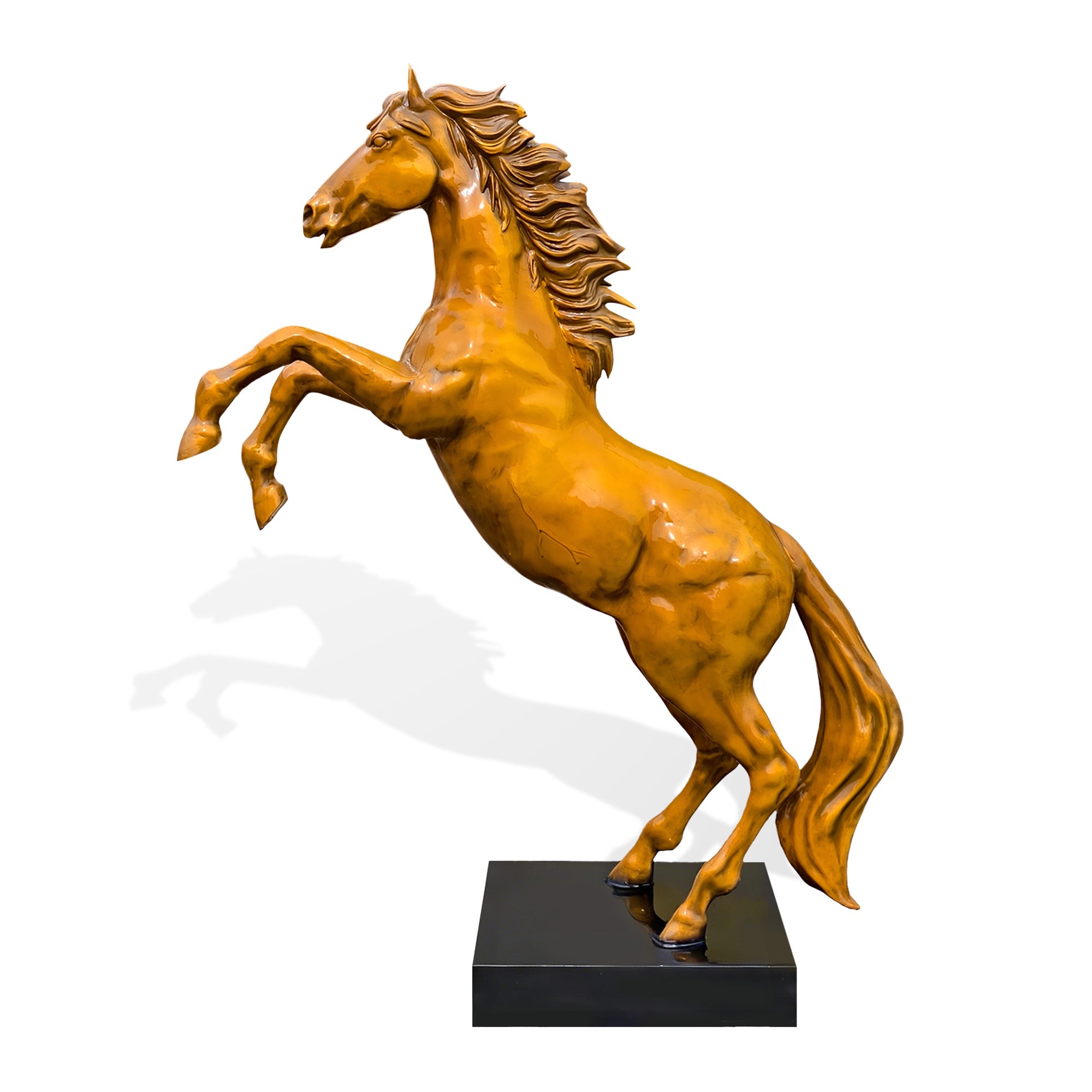 Side profile of a golden bronze Chinese zodiac horse sculpture on a black base with elevated front legs, powerful hindquarters, flowing tail, detailed mane, and dynamic rearing pose
