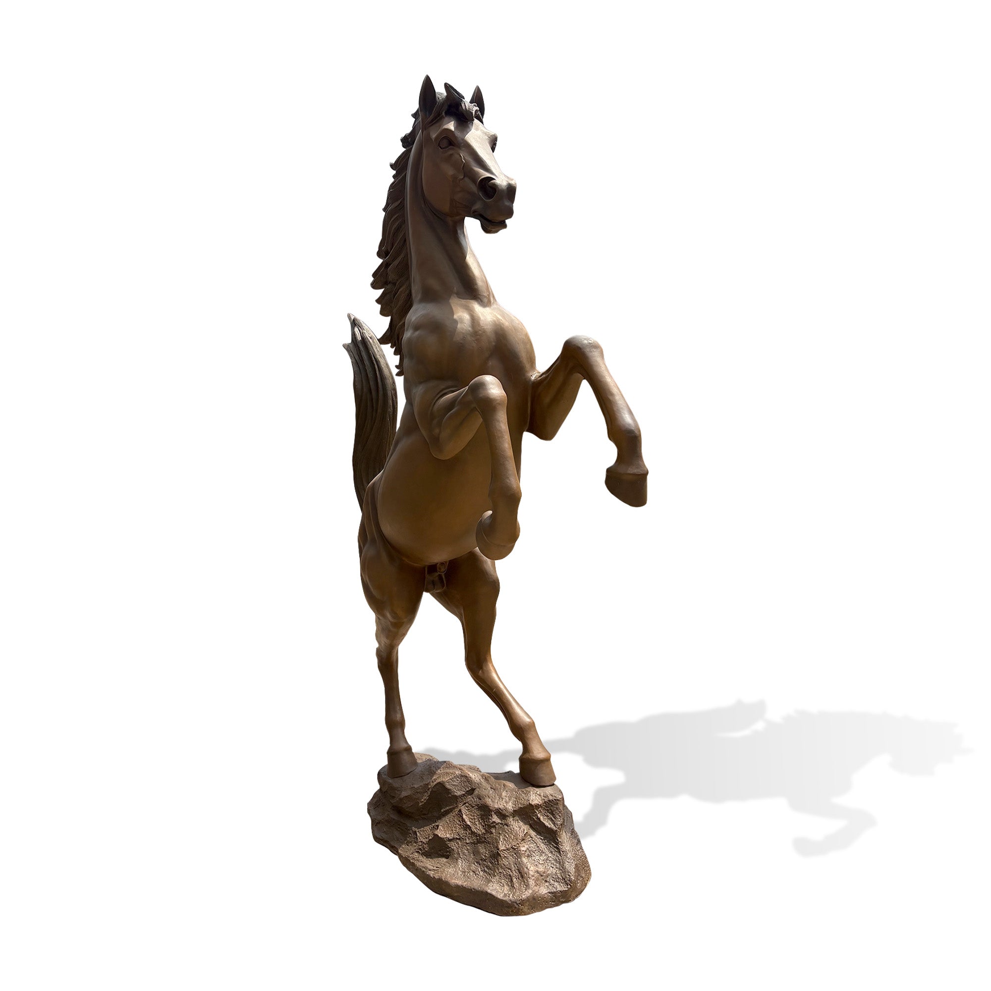 Side view of a bronze rearing horse sculpture on a rocky base with elevated front legs, strong hindquarters, flowing mane, raised tail, and dynamic upward posture