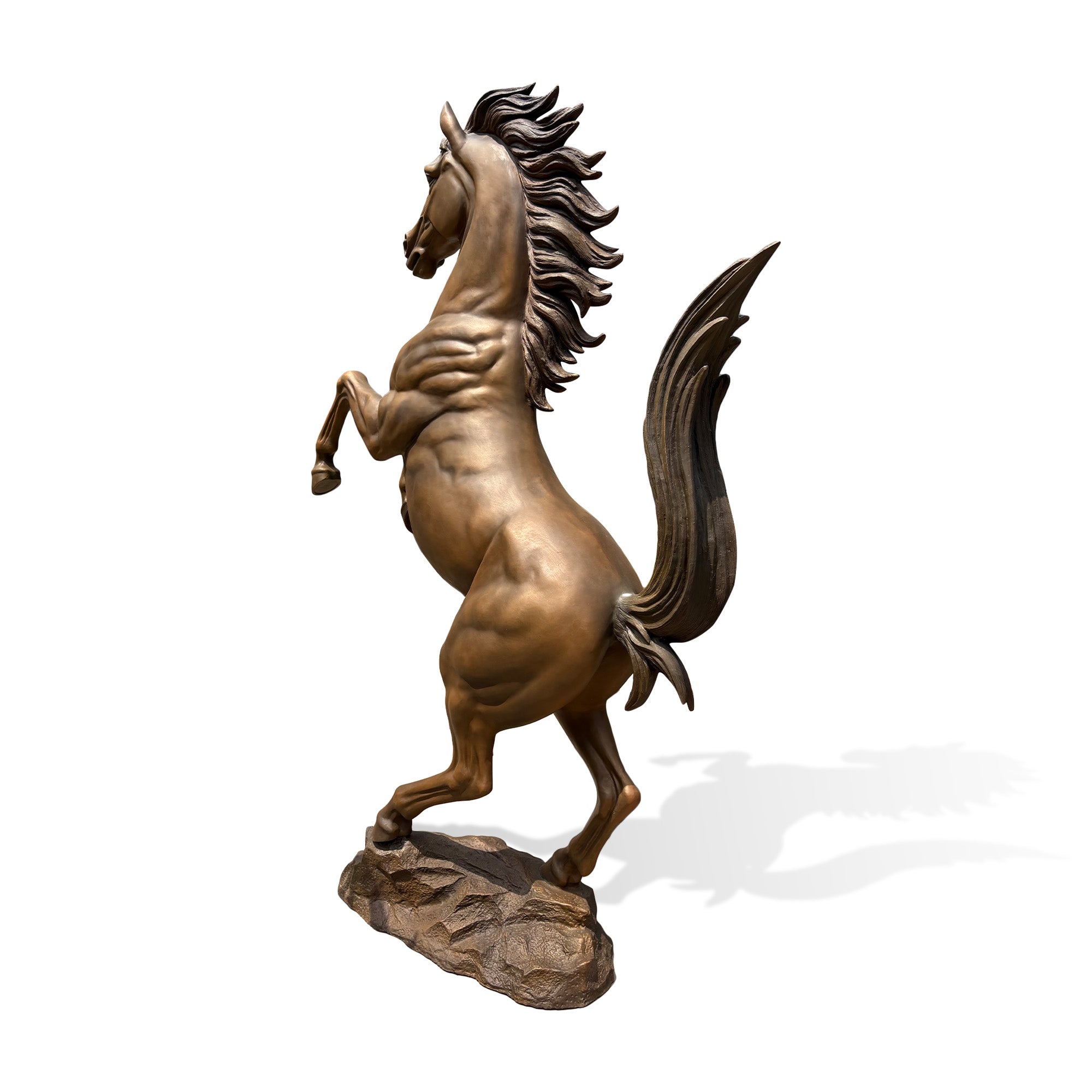 Rear view of a bronze rearing horse sculpture standing on a rocky base with raised front legs, flowing tail, detailed mane, and muscular hind legs.