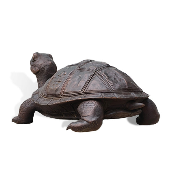 Rear view of an antique bronze turtle garden sculpture showing the patterned shell, textured legs and small tail