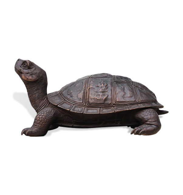 Full side view of a dark antique bronze turtle statue with raised head, extended legs and detailed geometric shell pattern