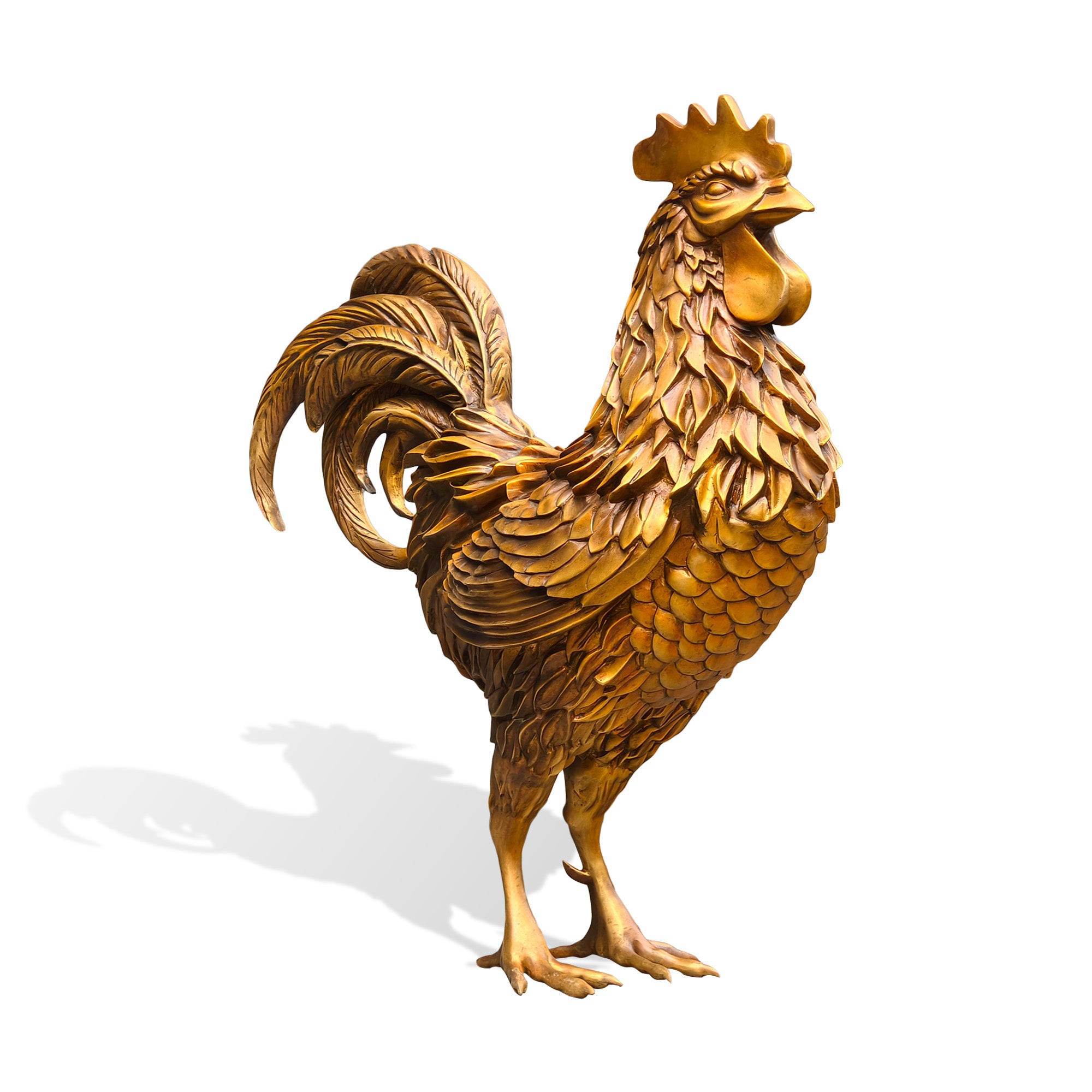 Side profile view of a golden bronze zodiac rooster statue with raised comb, flowing tail feathers, layered body plumage, detailed claws, and Chinese zodiac symbolism on a white background.