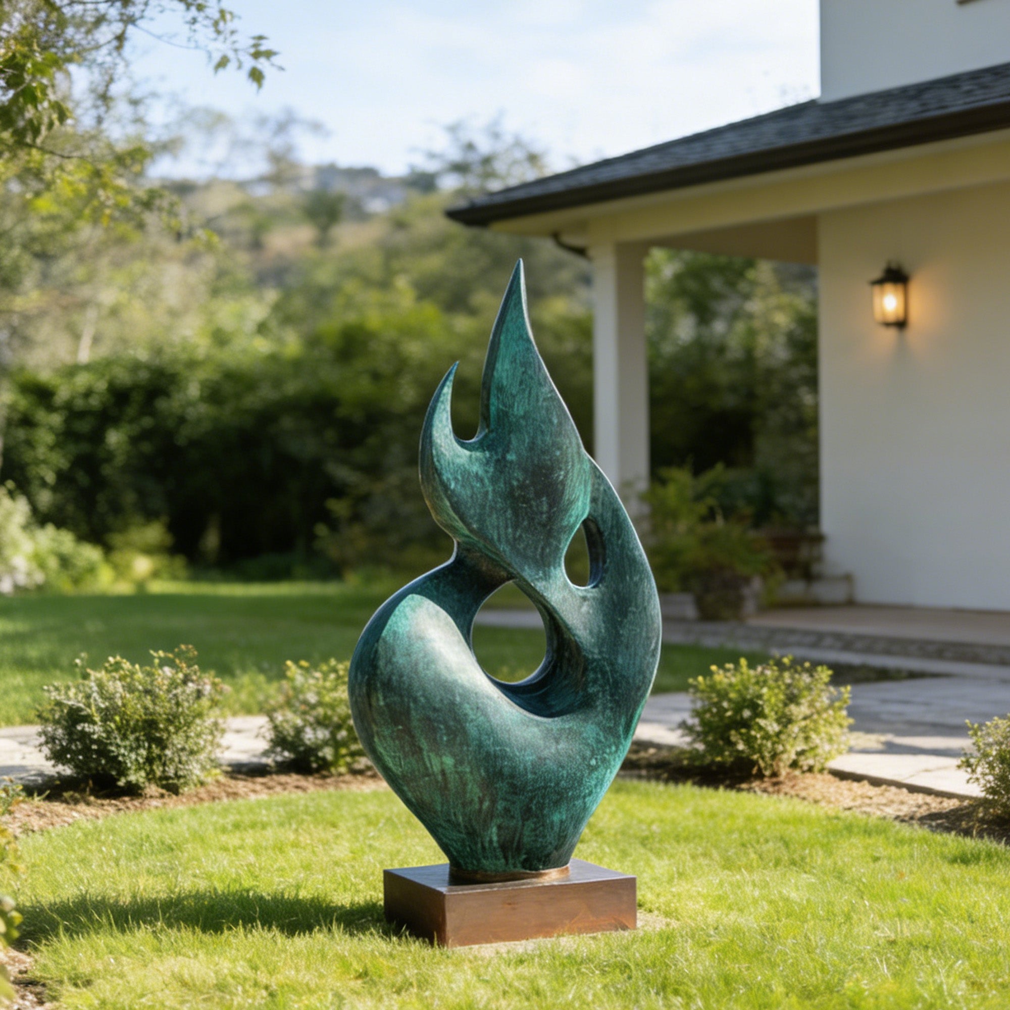 Verdigris bronze abstract flame sculpture displayed in a garden courtyard with flowing leaf-like curves, open circular cutouts, textured green patina, and square bronze base.