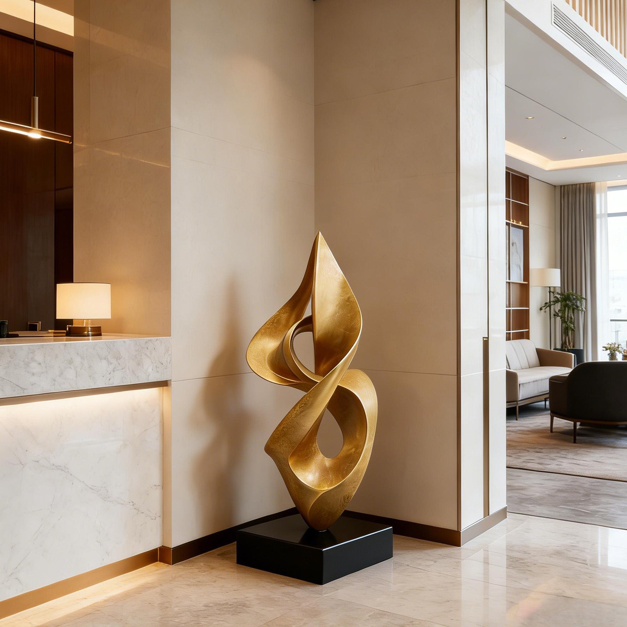 Gold bronze abstract ribbon sculpture displayed on a black pedestal in a luxury interior lobby with flowing vertical curves, open cutouts, and elegant modern decor.